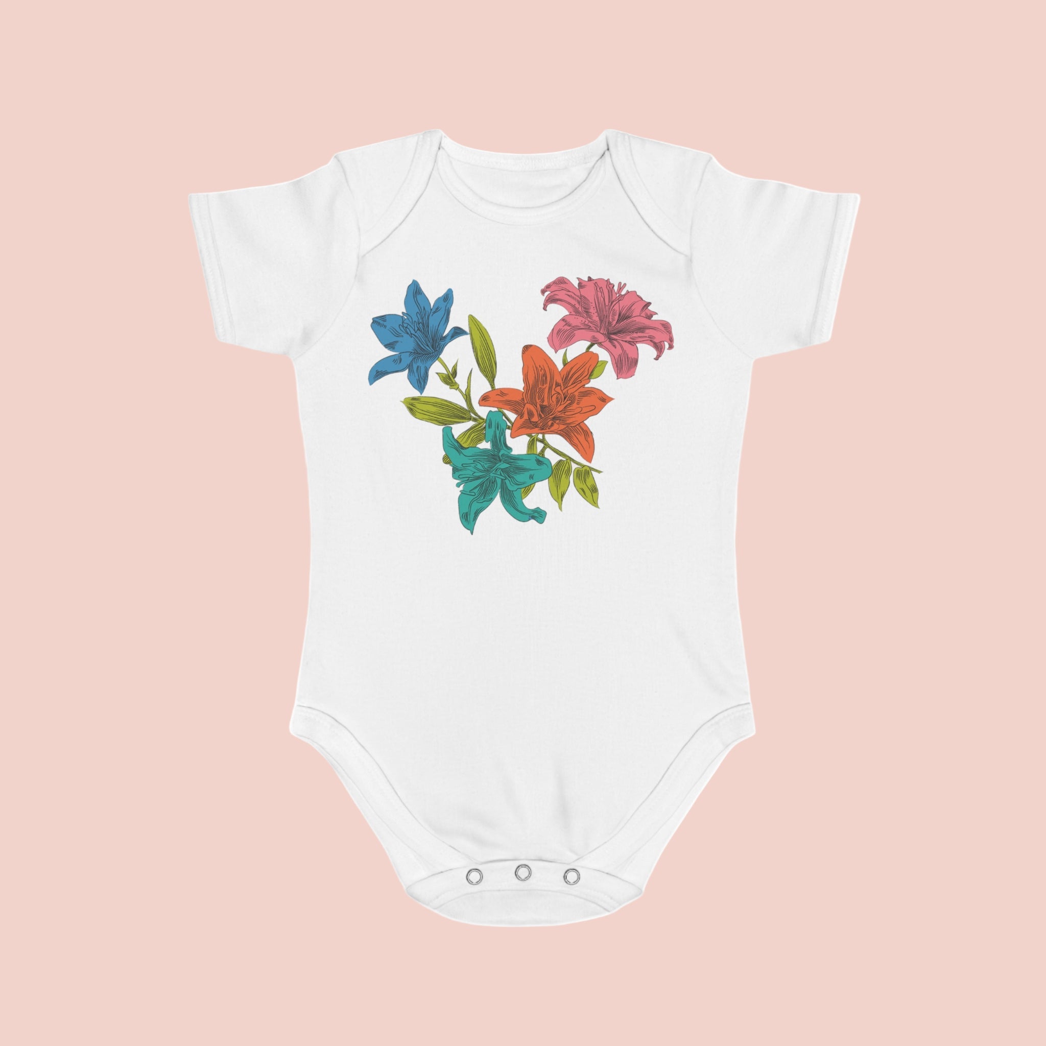 White baby onesie with colorful floral design on a pale background