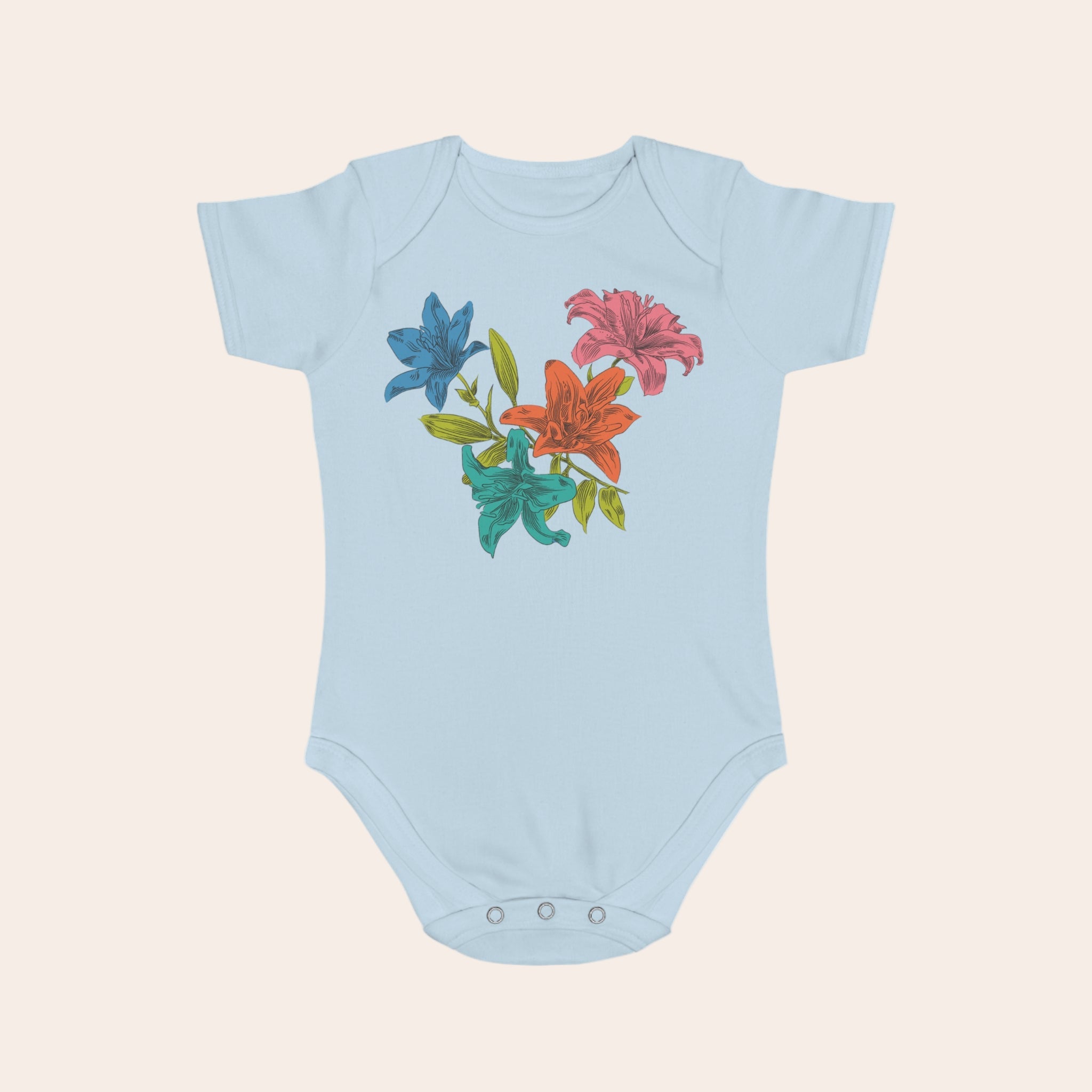 Light blue baby onesie with colorful floral design on a pale background