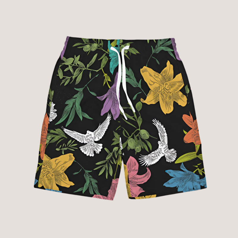 Black board shorts with an all-over, multi-colored pattern of flowers, olive branches, and doves, has white external ties and elastic waistband.
