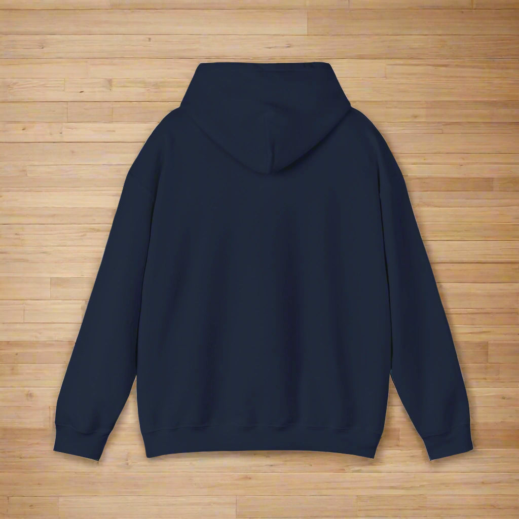 The back view of the navy hoodie laying flat on a wood floor, showing the garment without print or decoration on the back.