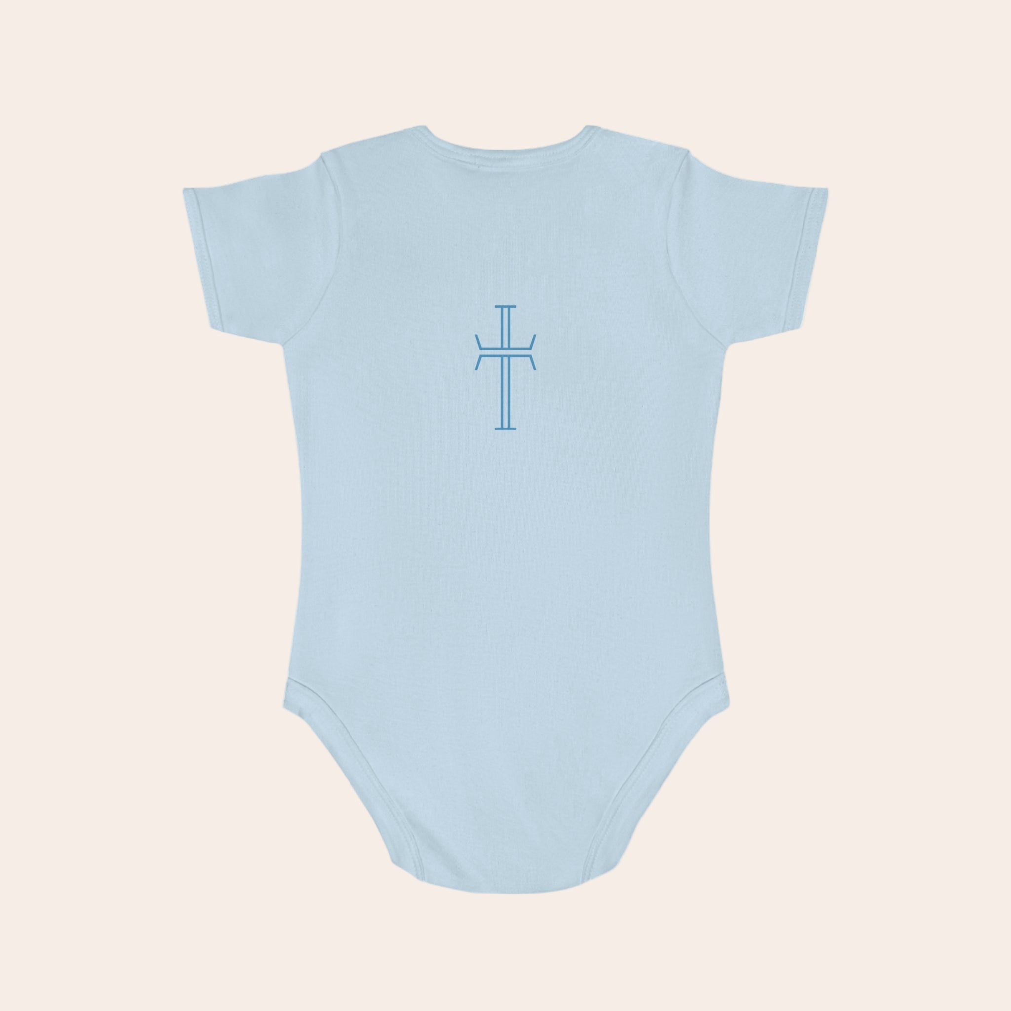 Light blue baby onesie with a cross design on a pale background