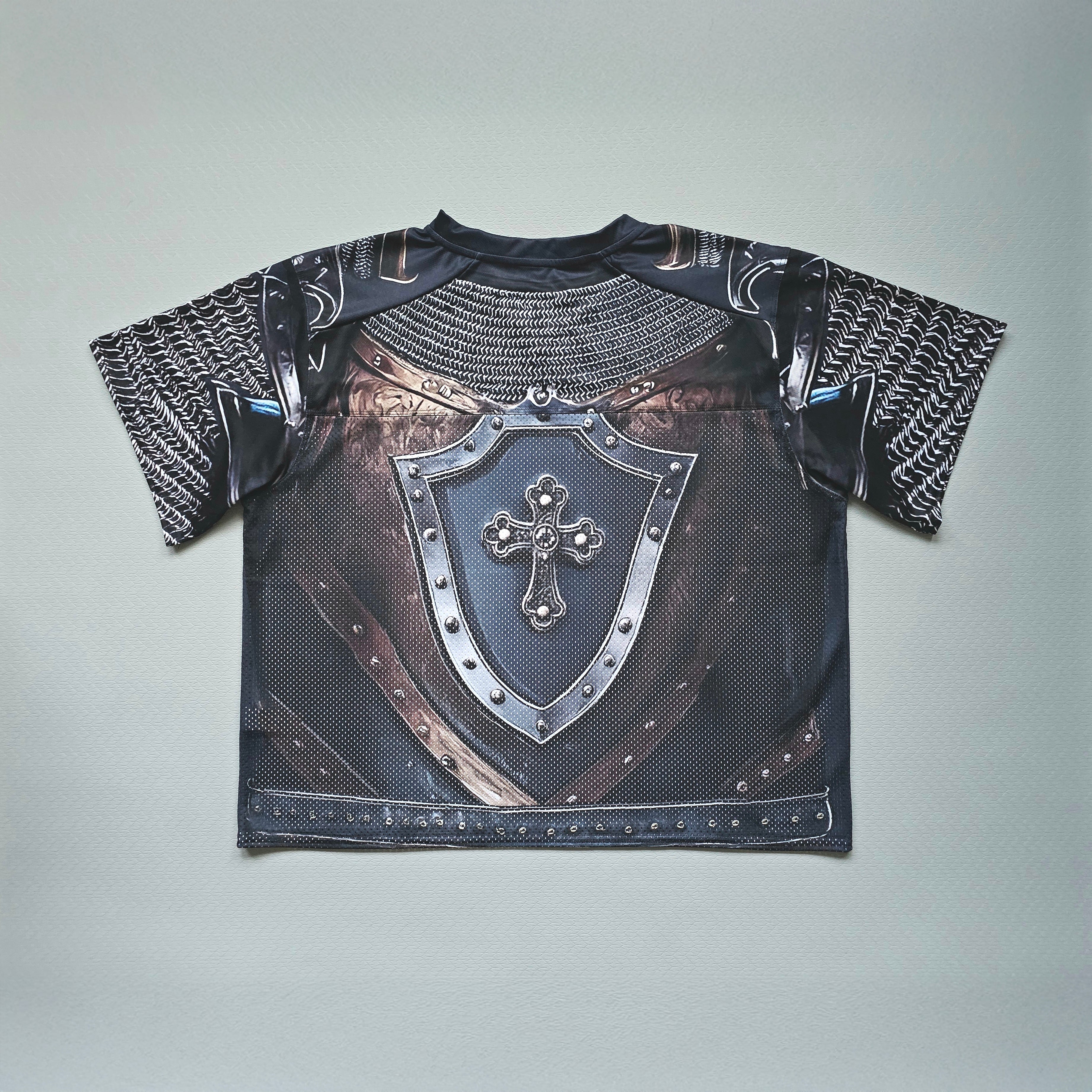 Black and silver armor football jersey with chainmail sleeves on a light gray background