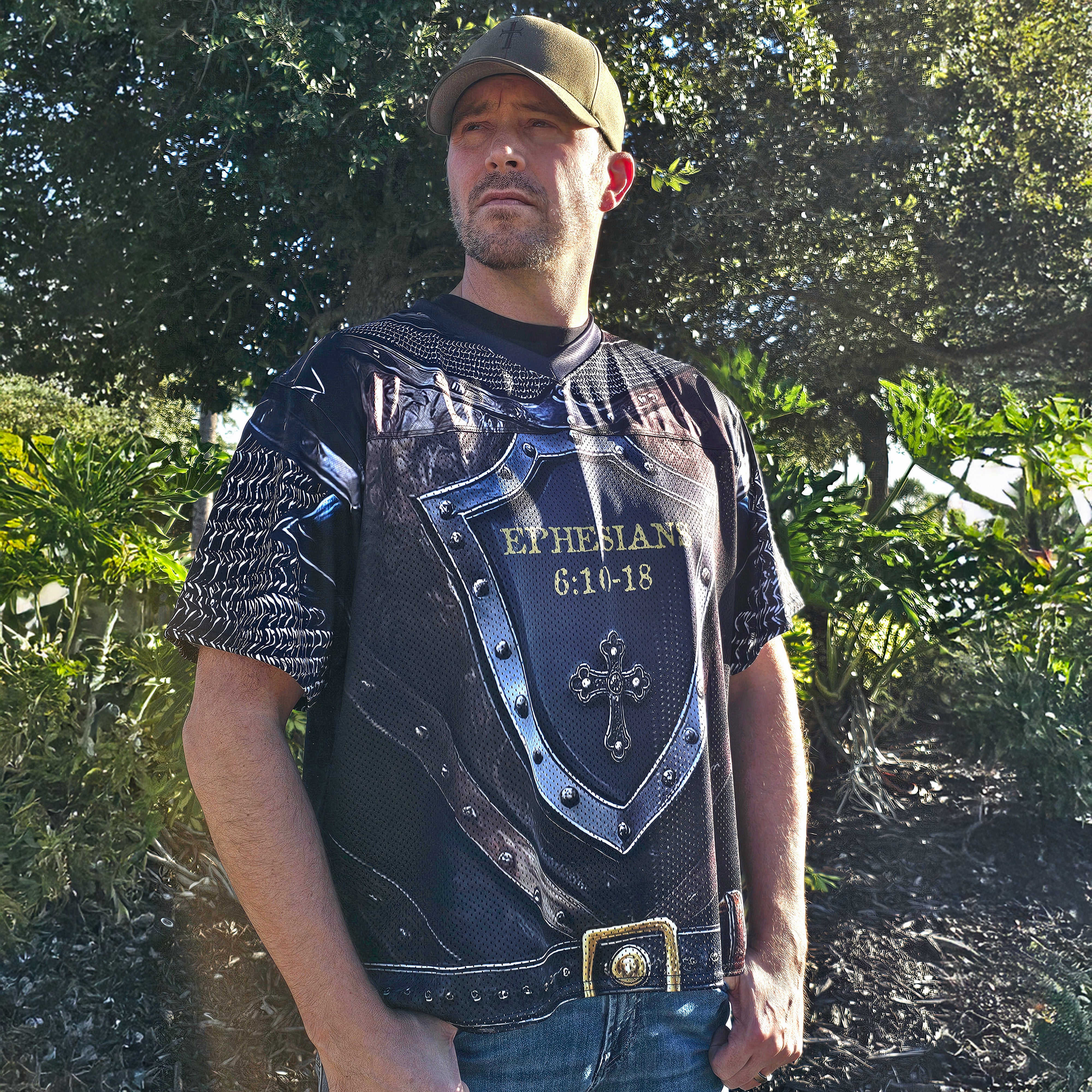 Man wearing a decorative football jersey with religious text and graphics outdoors.