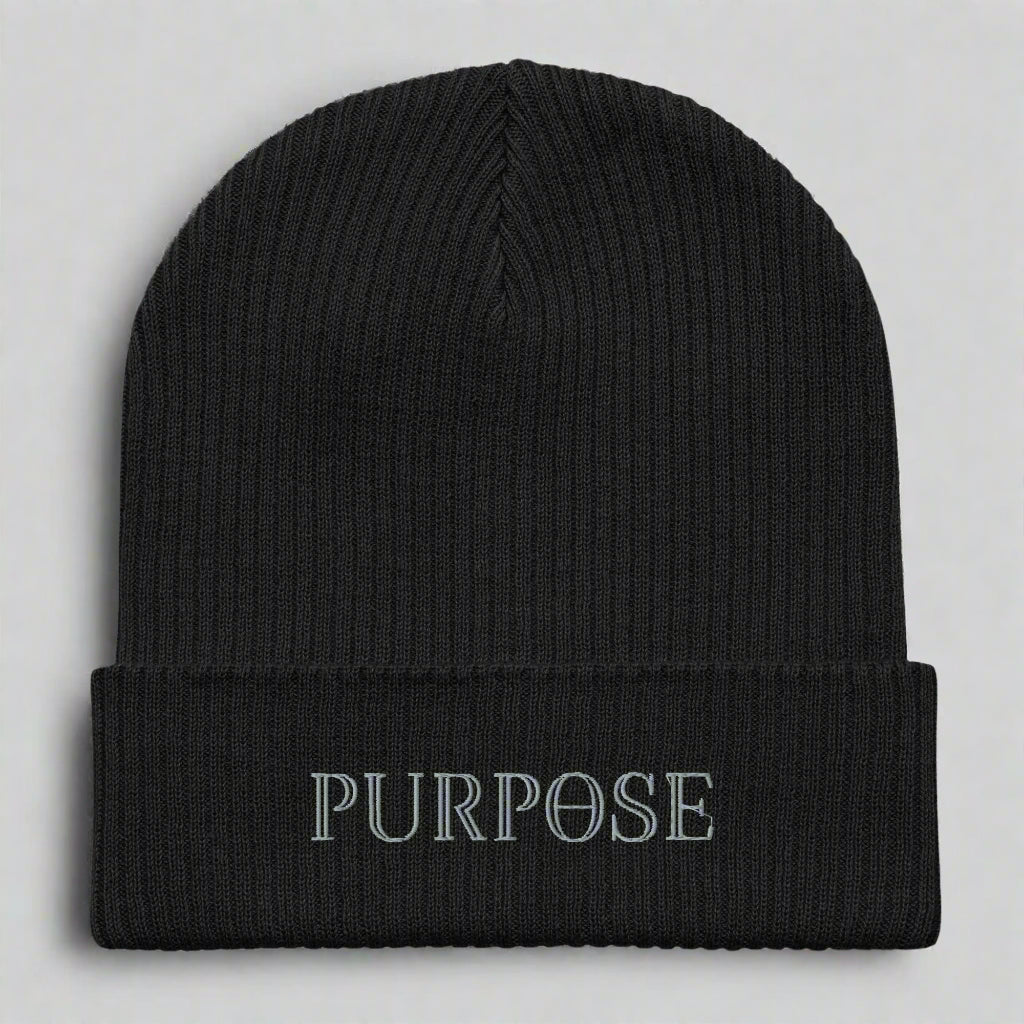 Black beanie with 'PURPOSE' embroidery on a light gray background
