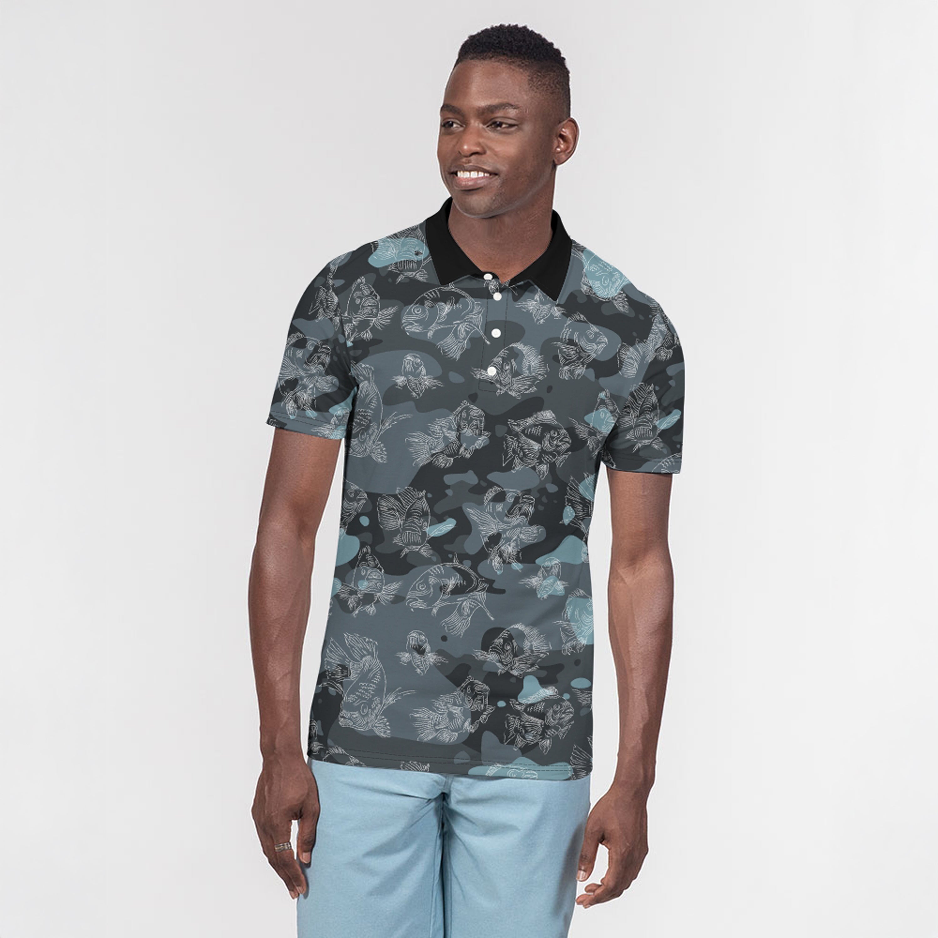 Man wearing a patterned polo shirt and light blue pants on a white background