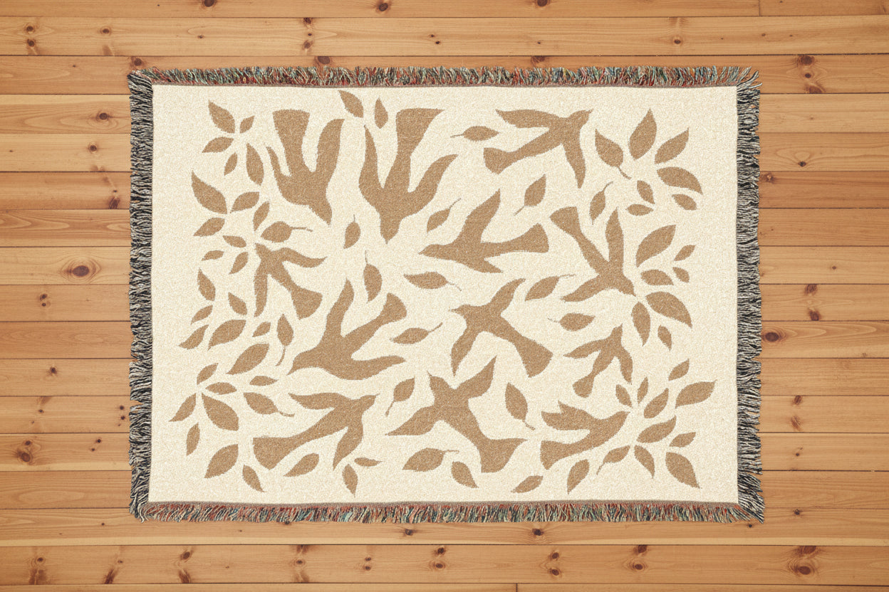Beige woven rug with leaf pattern on a wood floor