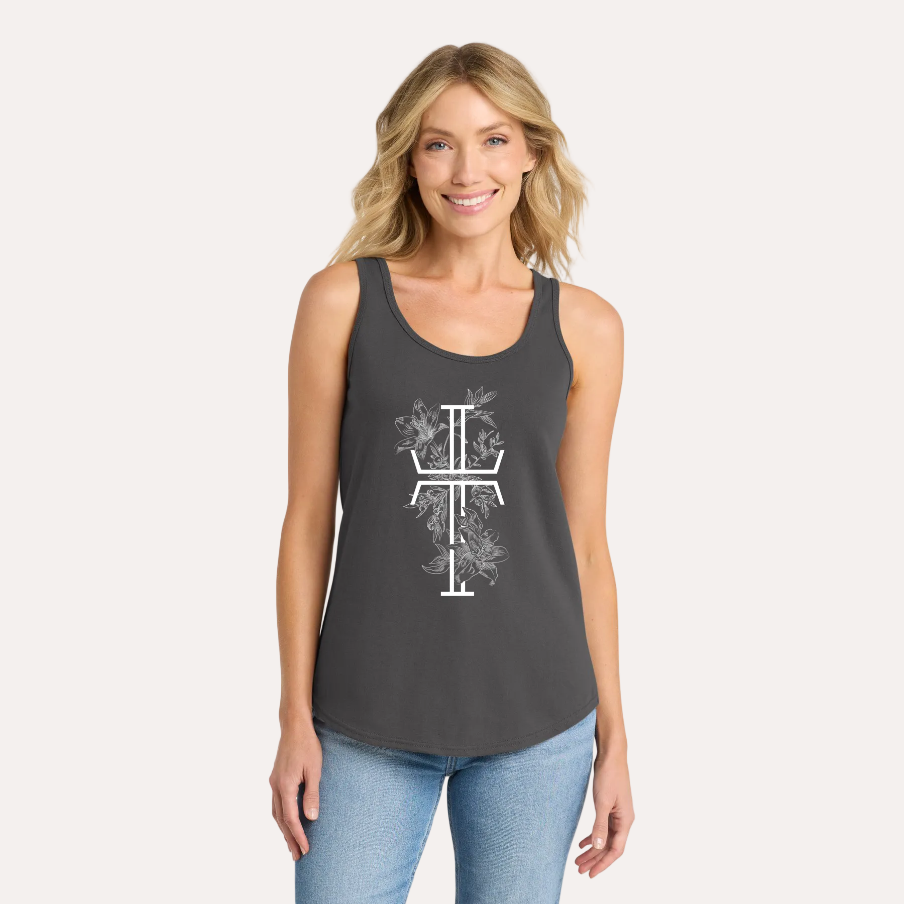 Woman wearing a dark gray tank top with a white floral cross design on a white background