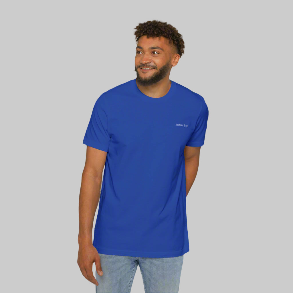 The front side of a male model wearing blue jeans and a blue tee shirt with the bible verse John 3:16 written in white on the left chest.