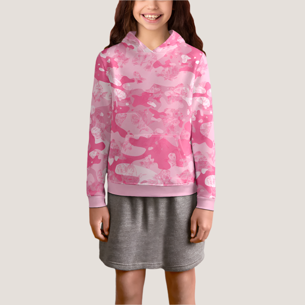 The front view of a female youth model in a gray skirt is wearing a pink-camo hoodie with a dark pink, all-over print line drawing of swimming carp. The hoodie has ribbed banding along the cuffs and bottom, and a kangaroo pocket.