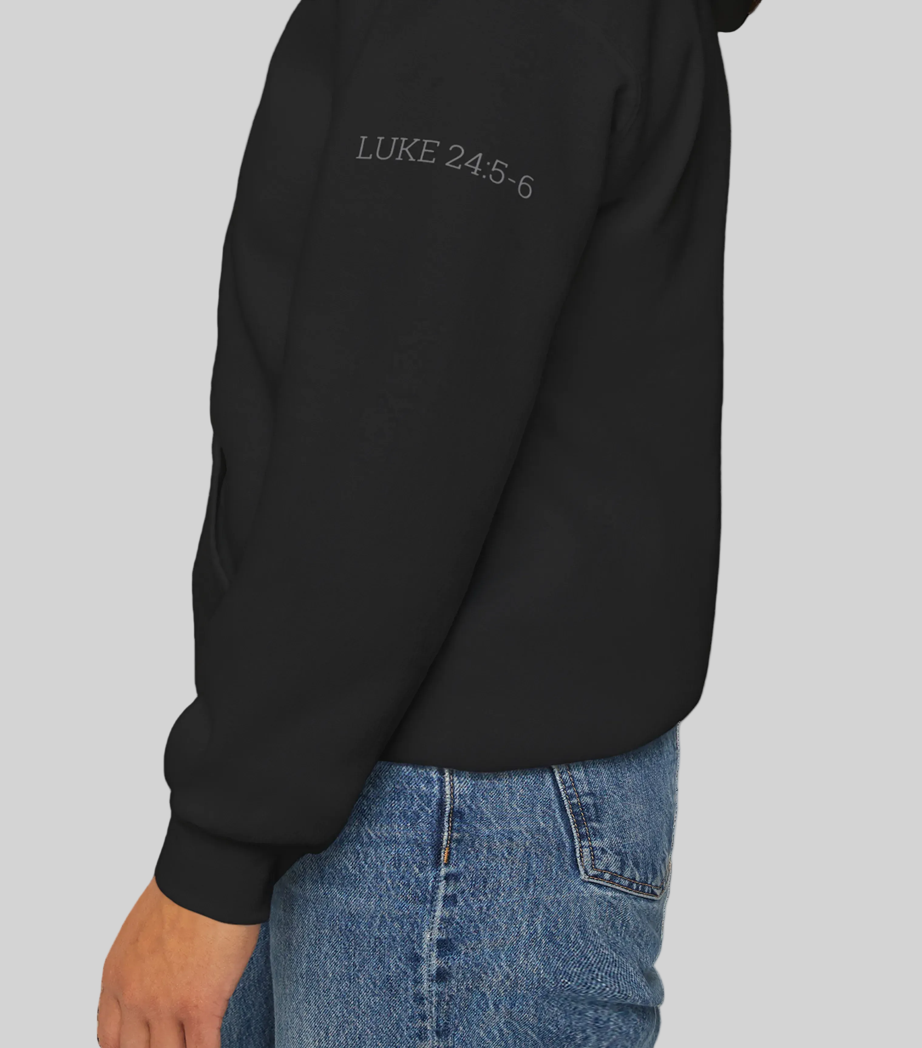 Black hoodie with Bible Verse Luke 24:5-6 text against a white background