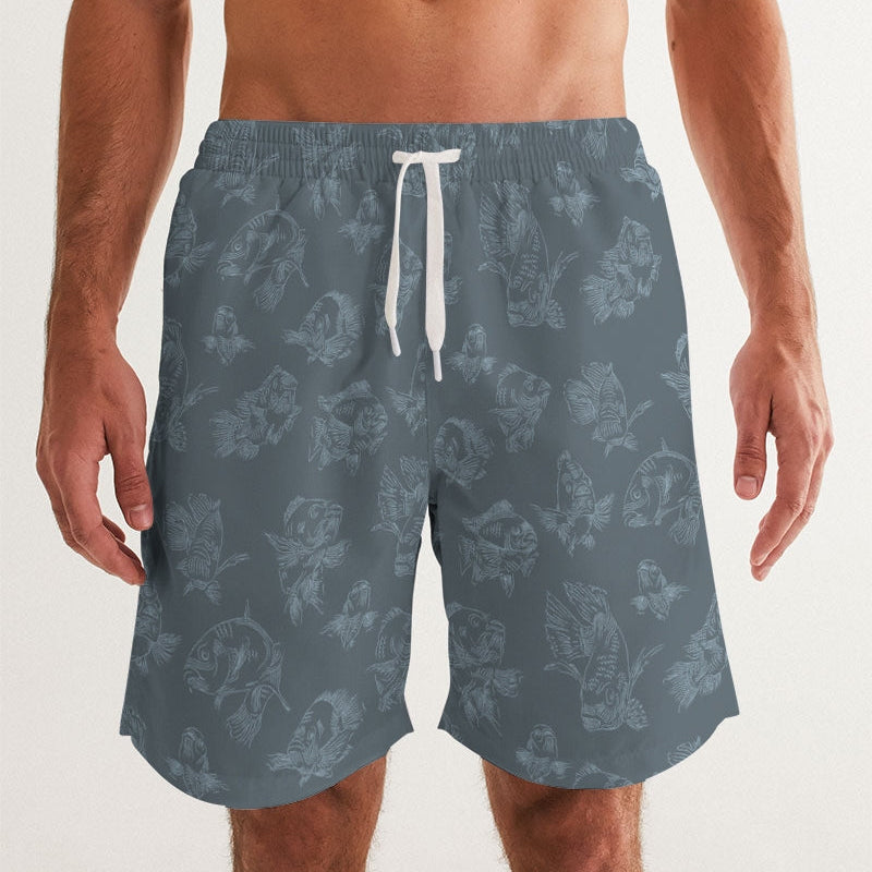 Blue swim shorts with fish pattern and a white drawstring on a plain background