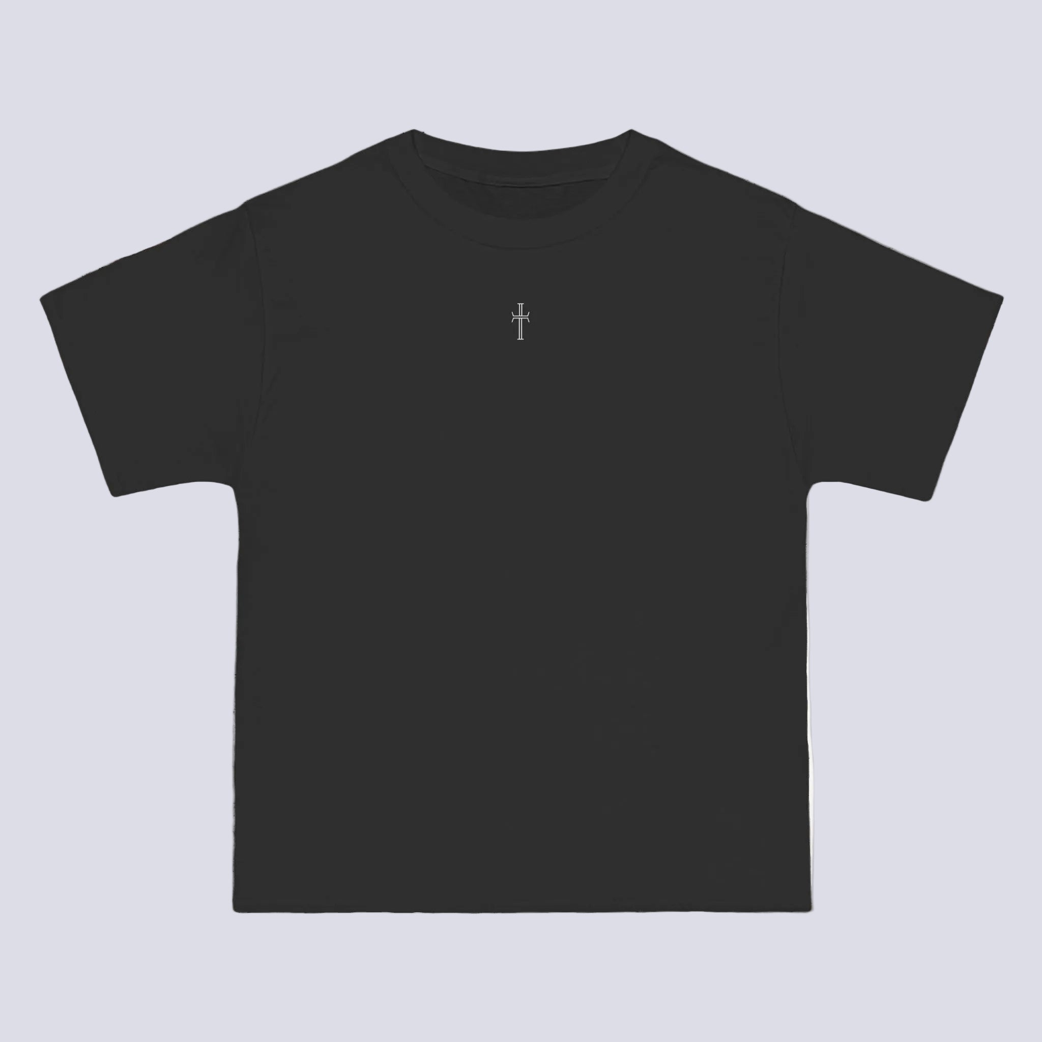 A black crewneck tee shirt displays the front of the garment. A small white cross logo is printed at the top center.