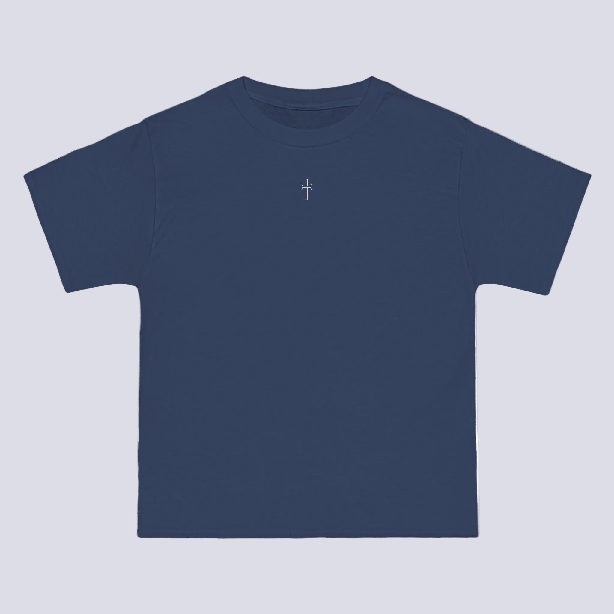 A denim blue crewneck tee shirt displays the front of the garment. A small white cross logo is printed at the top center.