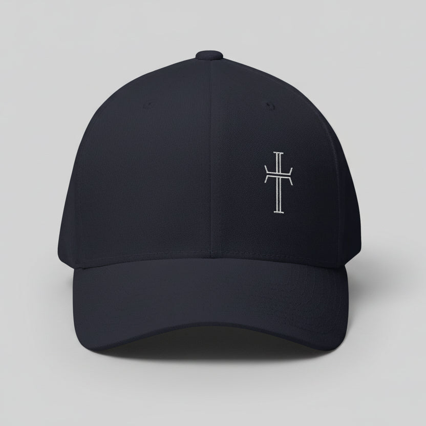 Front of dark navy cap with a white cross on front left panel against a gray background