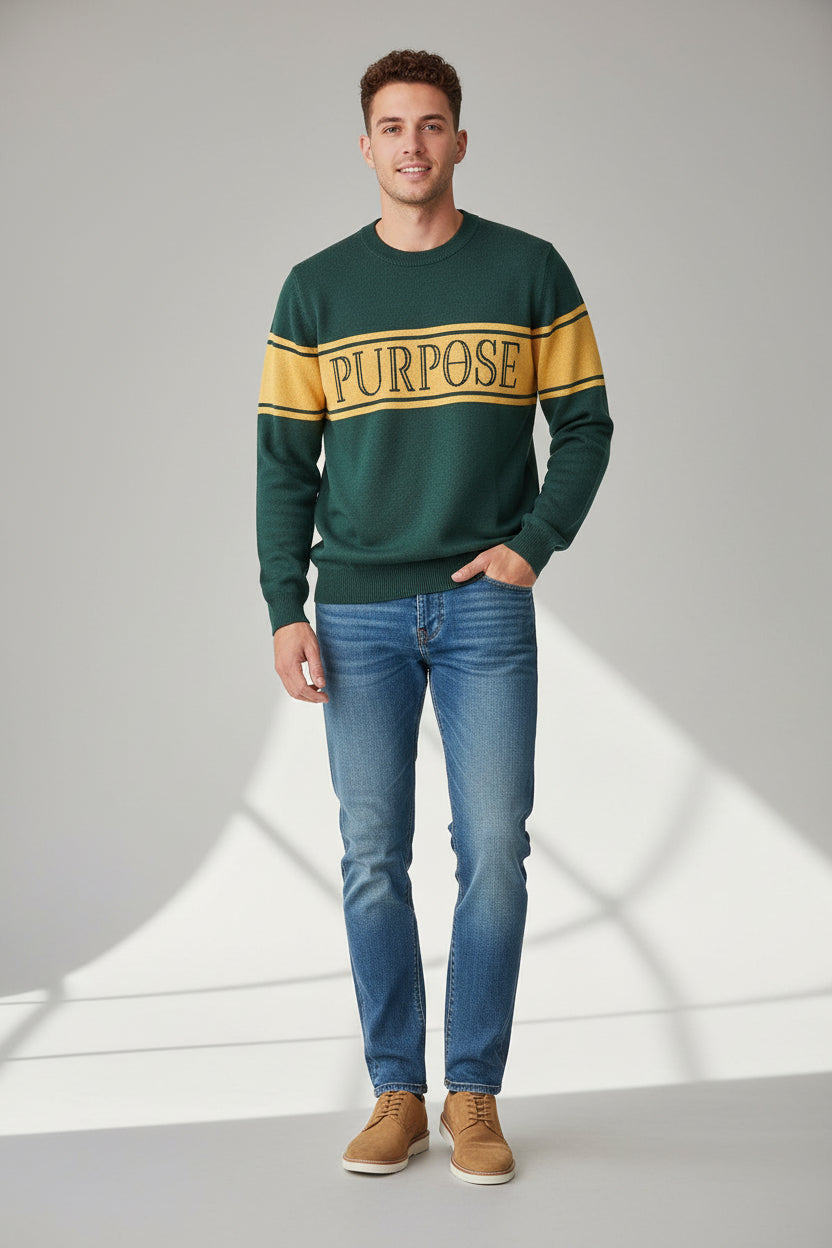 The forest green sweater is laying against a white background. The three mustard-colored stripes across the center chest and upper arms are displayed. The word "Purpose" in forest green capital letters on the center of the chest is depicted.