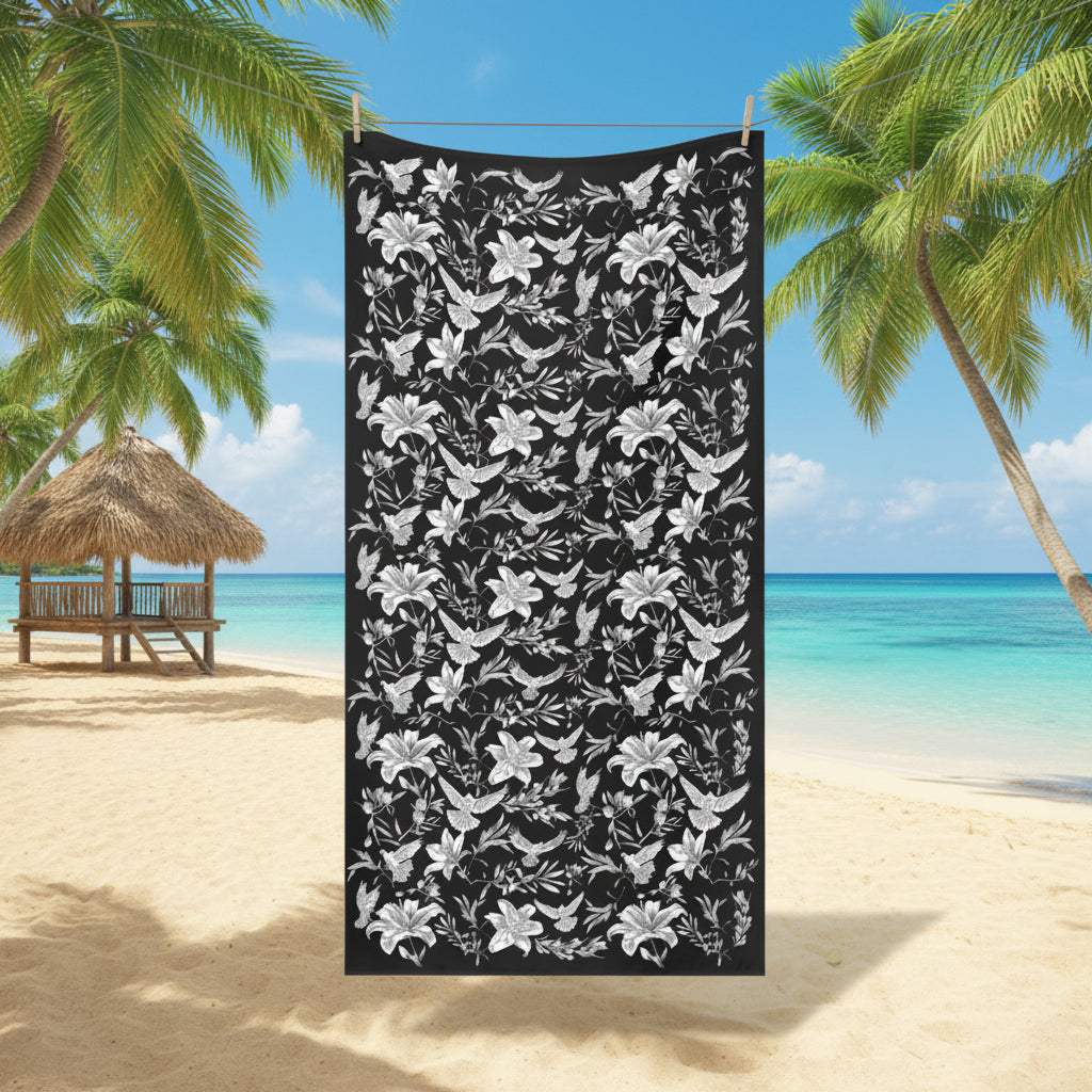 Black towel with white floral and dove pattern hanging on a line