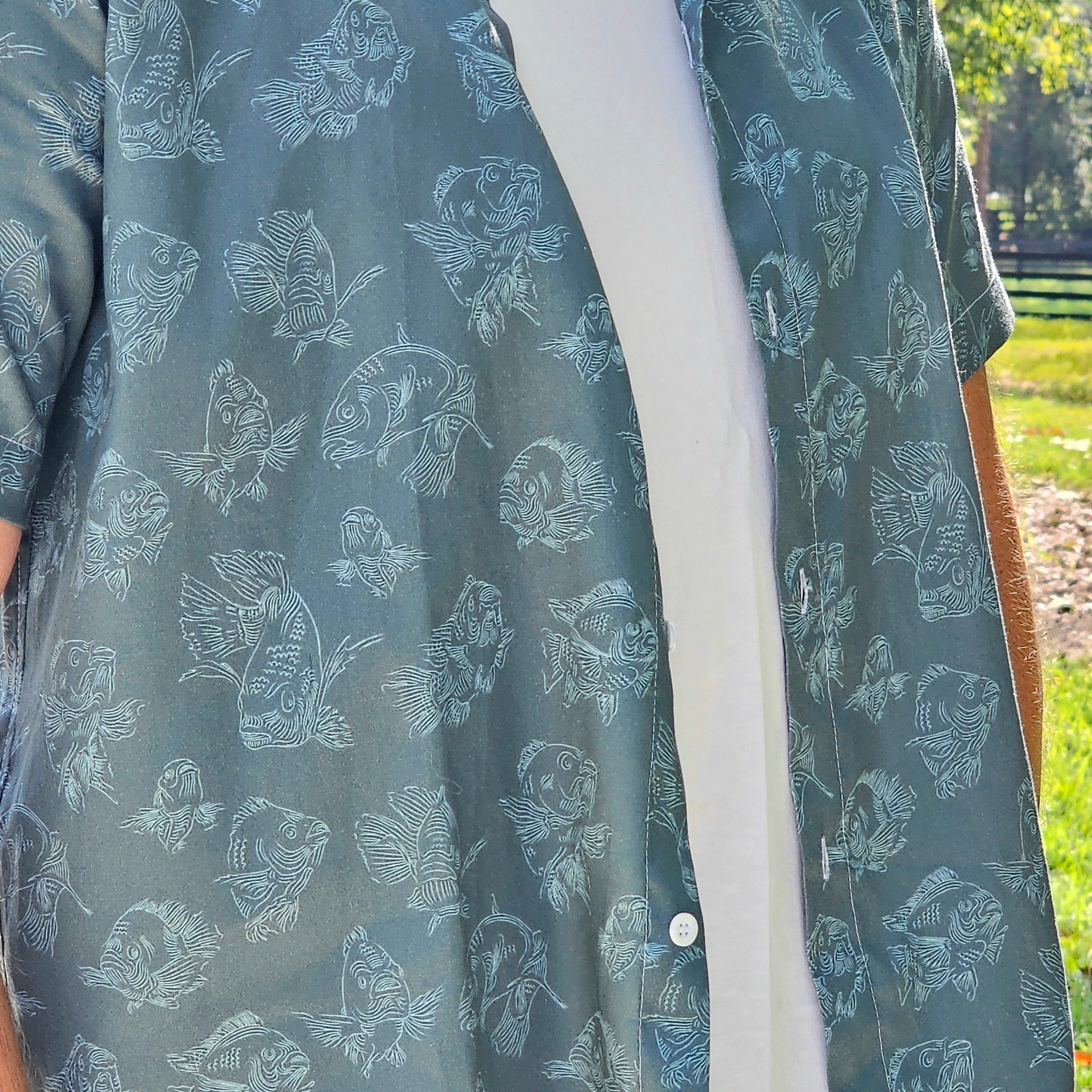Slate-patterned shirt with white buttons and trim, worn outdoors.