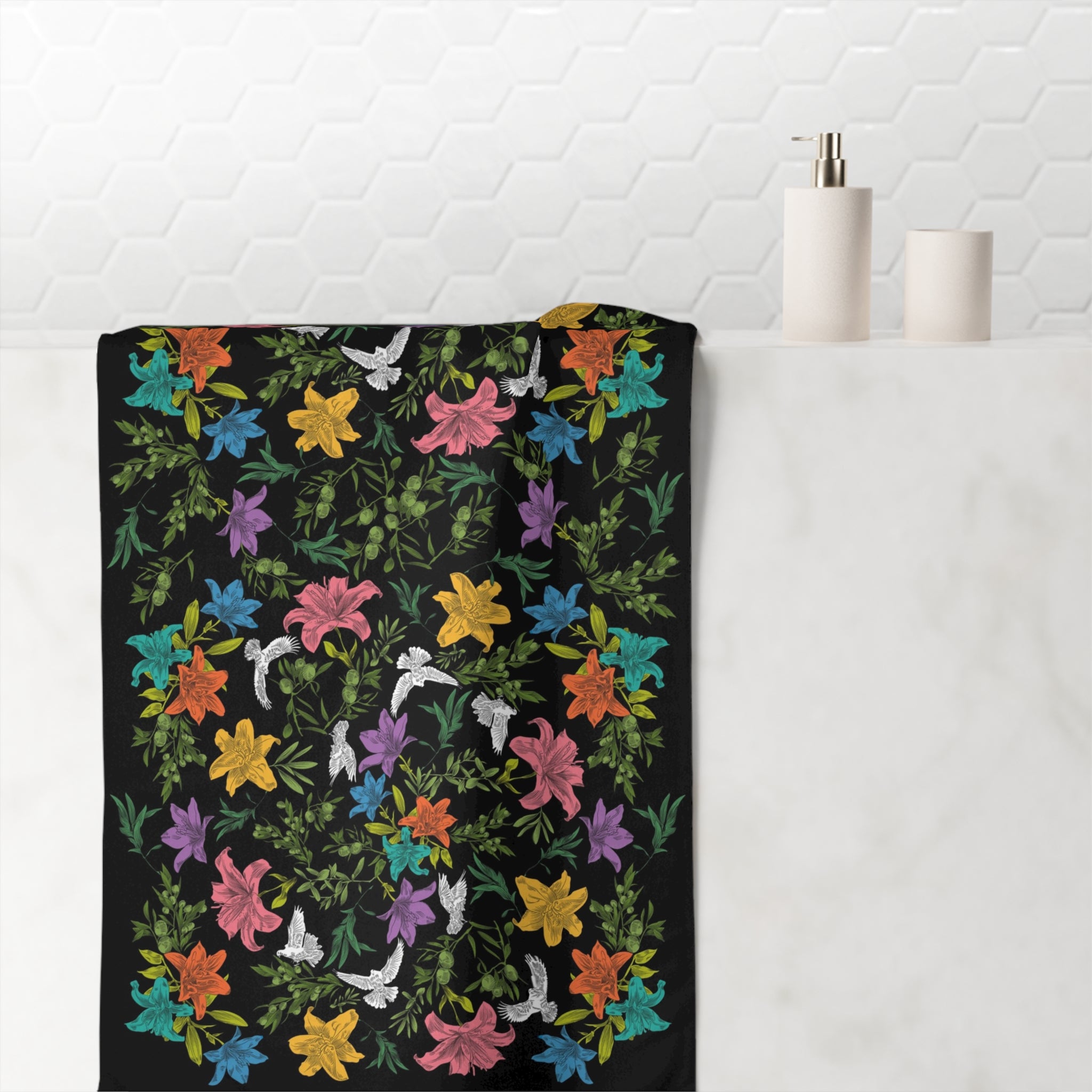 Black towel with colorful floral pattern on a white background bathroom.