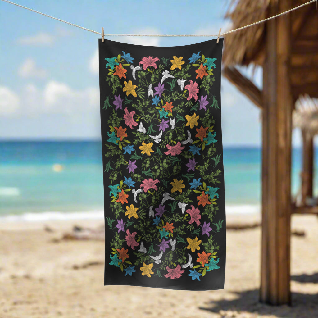 Colorful floral patterned towel on a clothesline with a beach background