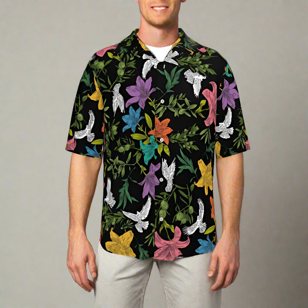 Person wearing a colorful floral and bird patterned shirt against a plain background