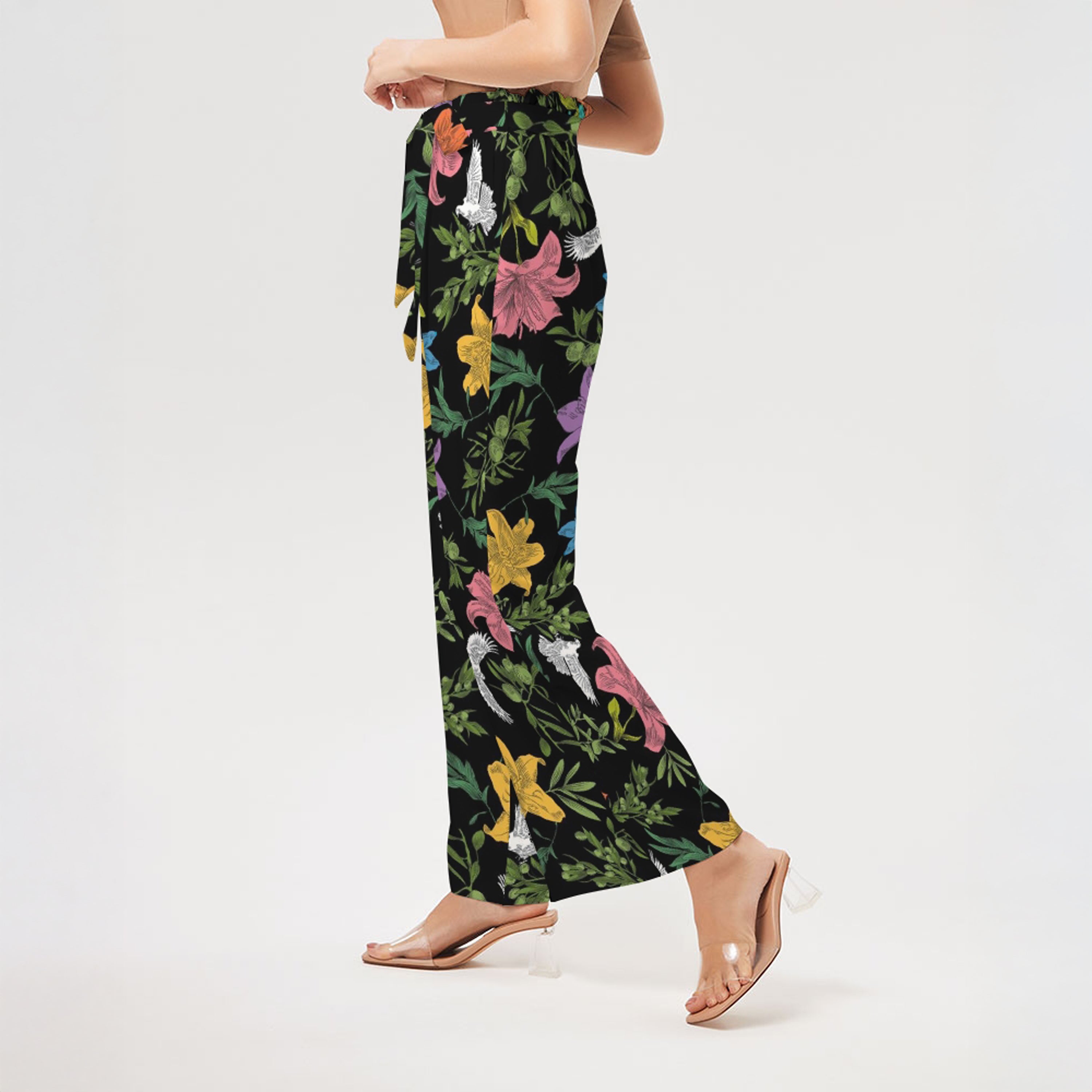 Left side of floral patterned pants worn by a person on a white background