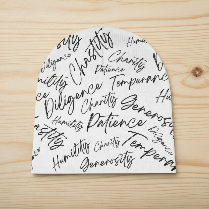 White beanie with black text on a pale background