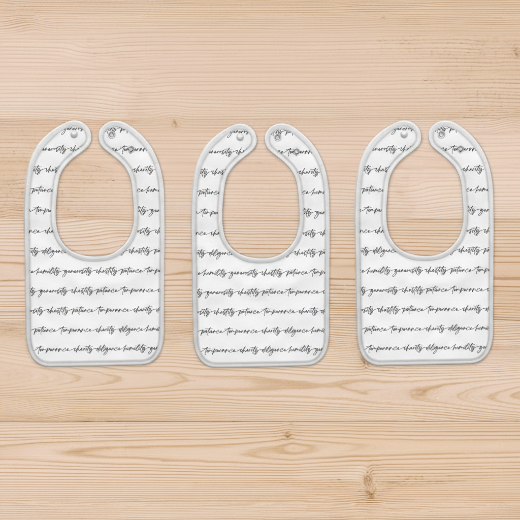 Set of three baby bibs with the seven virtues in script font across the bib.