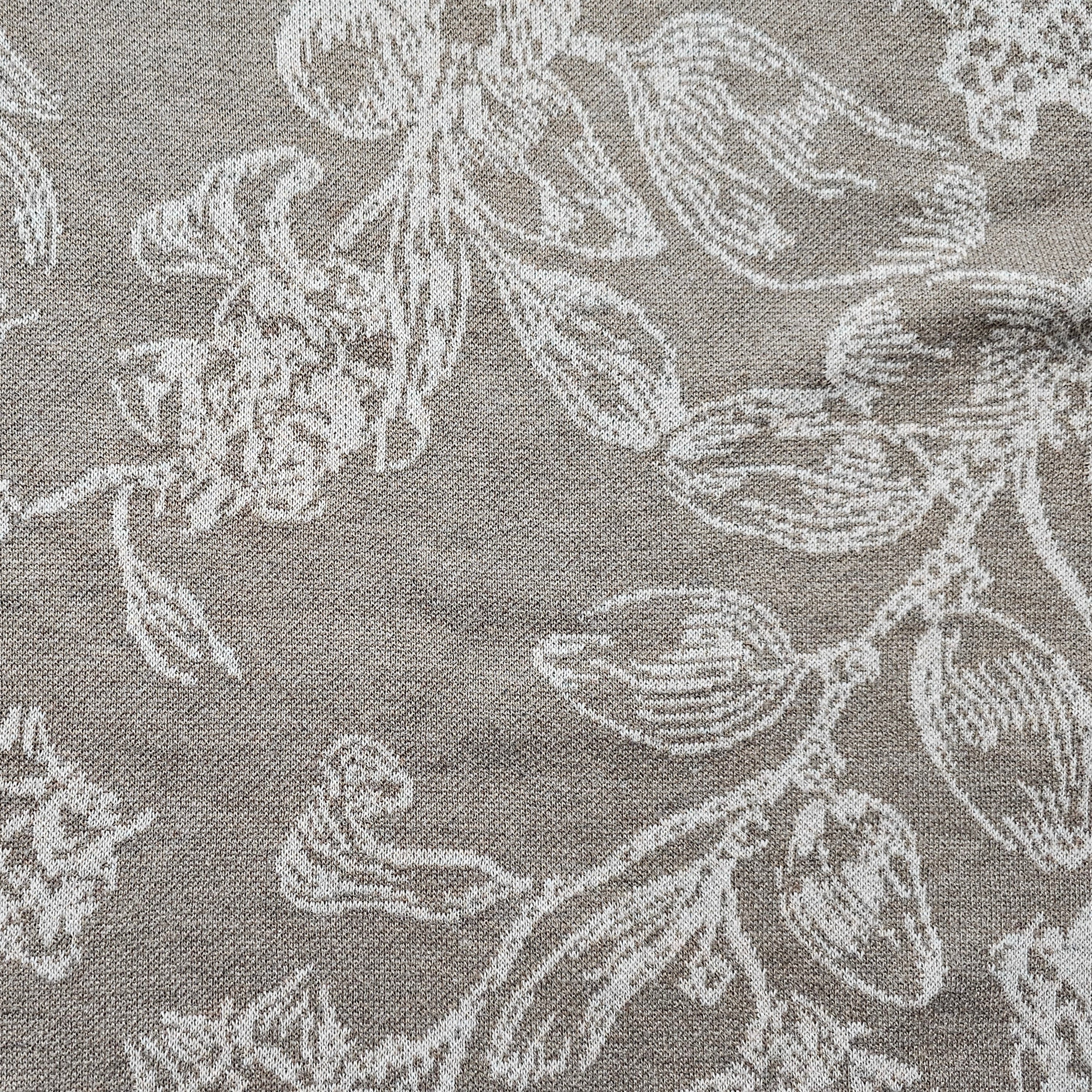 Brown knitted fabric with light floral pattern