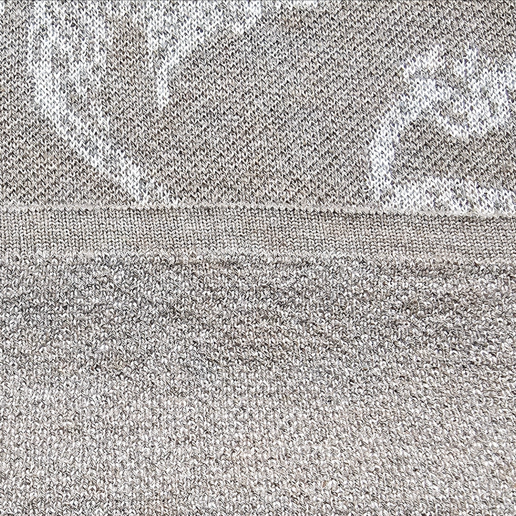Close-up of gray knit fabric with a subtle pattern and knit-incorporated hem