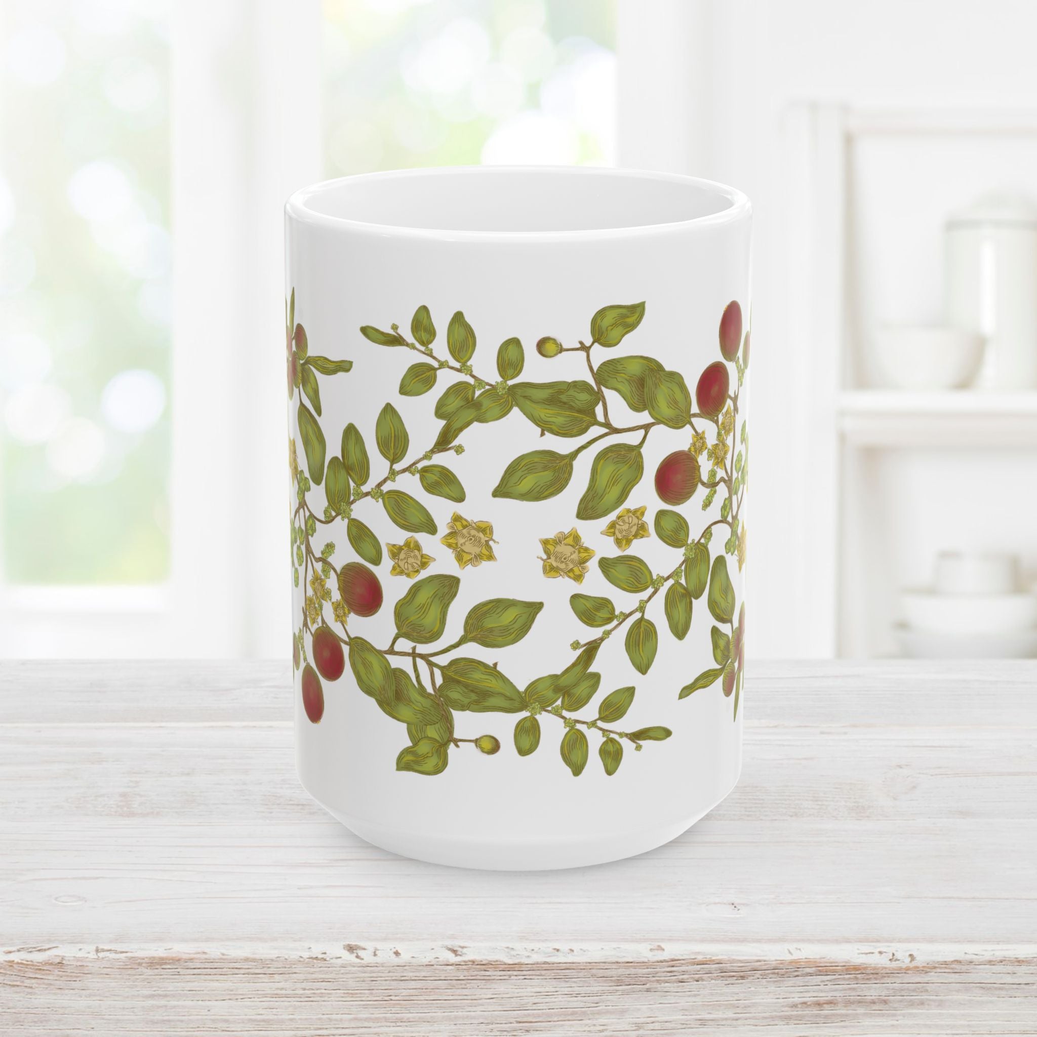 Front side of white mug with floral, berry, and leaf design on a wooden surface.
