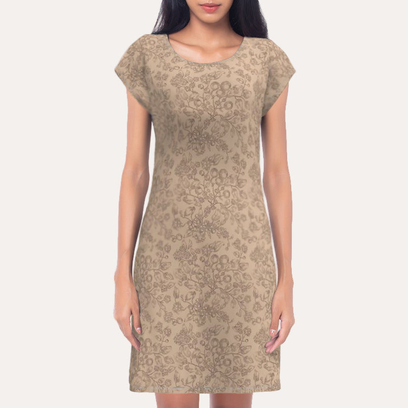 Woman wearing a beige patterned dress against a neutral background