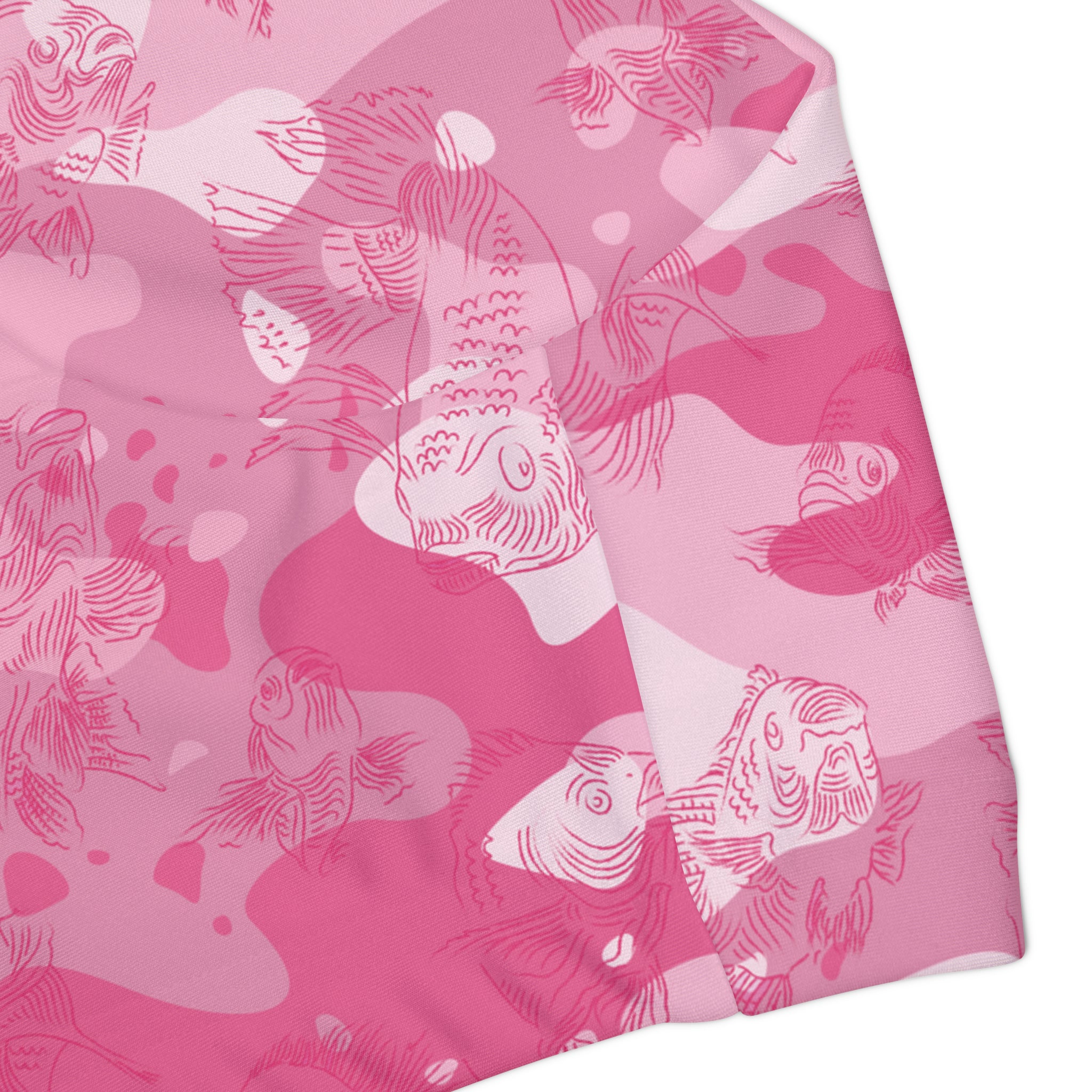 Close-up of the side of the tank swim top showing the finer details of the pink-camo design and all-over swimming carp pattern in dark pink.