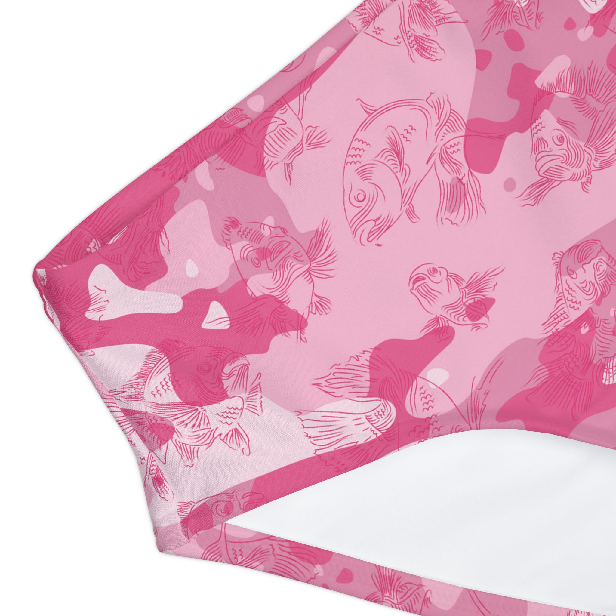 Close-up of the swim bottoms showing the finer details of the pink-camo design and all-over swimming carp pattern in dark pink.