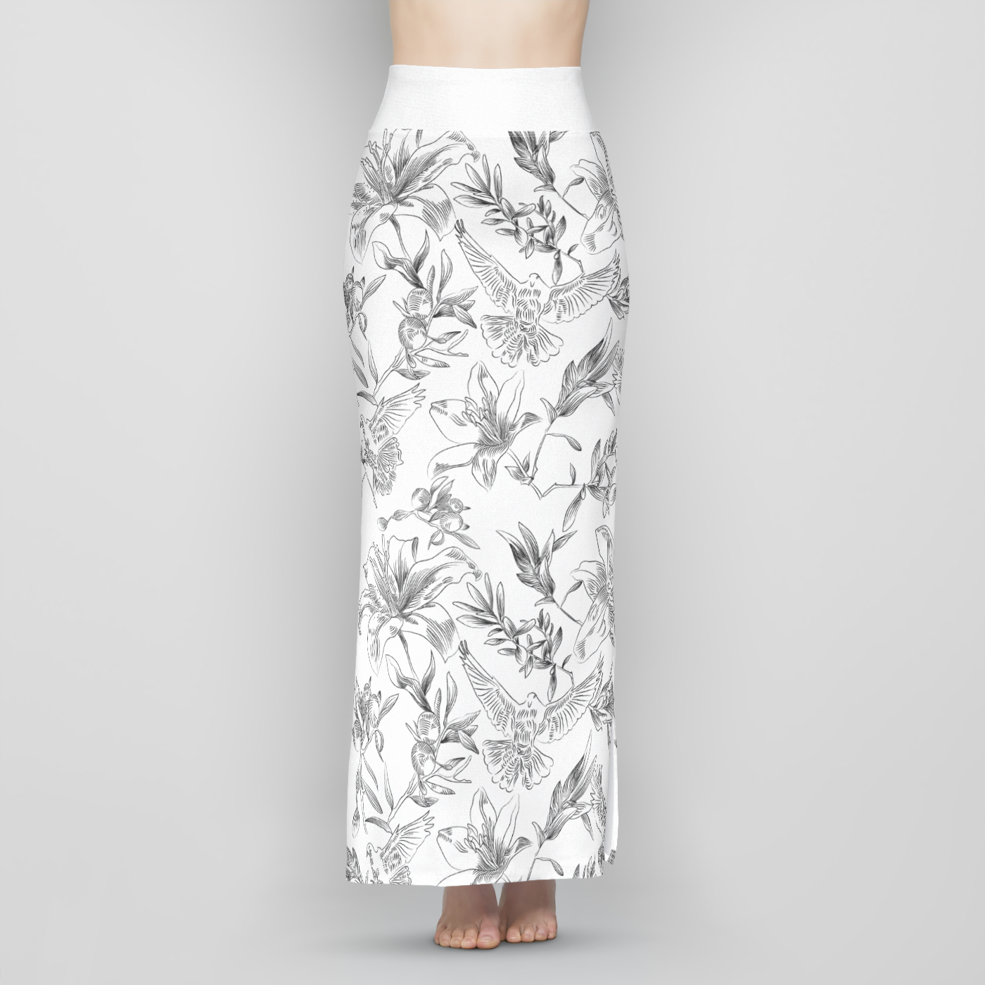 The front, lower half of a female model wearing a long, white, sheath-style, maxi skirt with a black line-drawing pattern of doves, flowers, and olive branches. The skirt is high-waisted with a wide, white band of fabric at the waist.