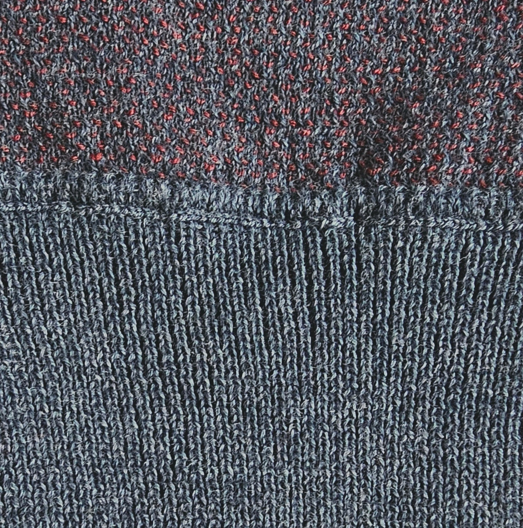 Close-up of the knitted seams of the ribbed cuff.