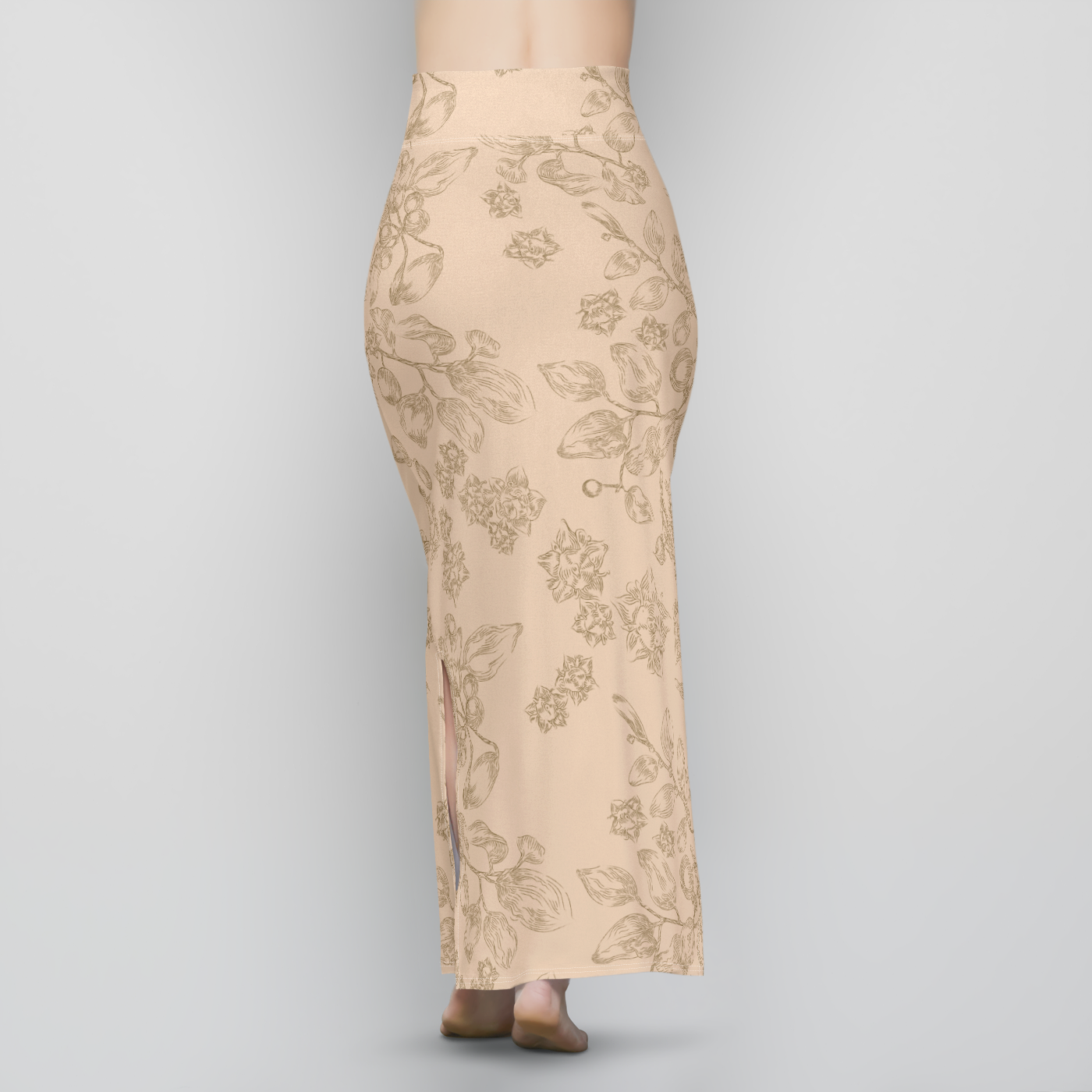 The back  lower half of a slender woman wearing a long, beige, sheath-style, maxi skirt with a dark brown line-drawing pattern of a plant with small flowers, berries, and leaves. The skirt is high-waisted with a wide band of patterned fabric at the waist.