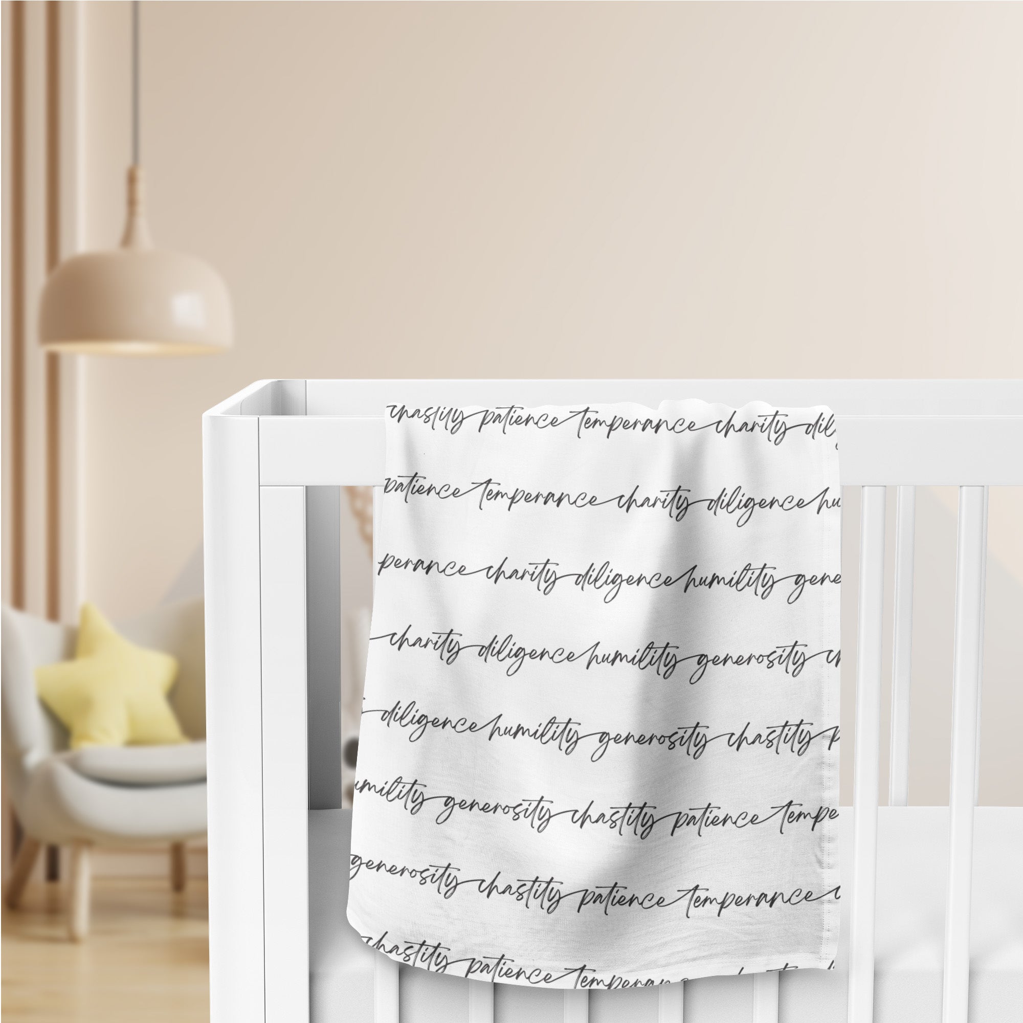 A white swaddle blanket, folded and draped over the side of a crib. The blanket has an all-over print of biblical virtues written in black script in continuous strips across the blanket face.