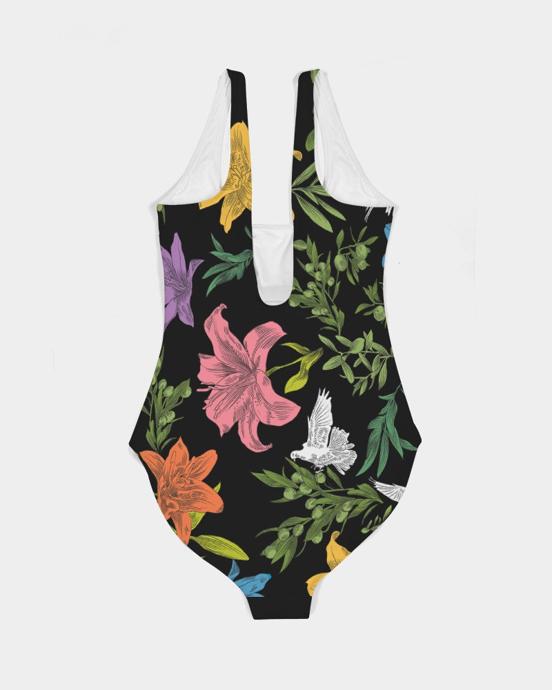 Back view of a black, one-piece, scoop-neck swimsuit with doves, flowers, and olive branches, creating a bold, multi-colored, all-over printed pattern. The swimsuit is laying flat against a white background.