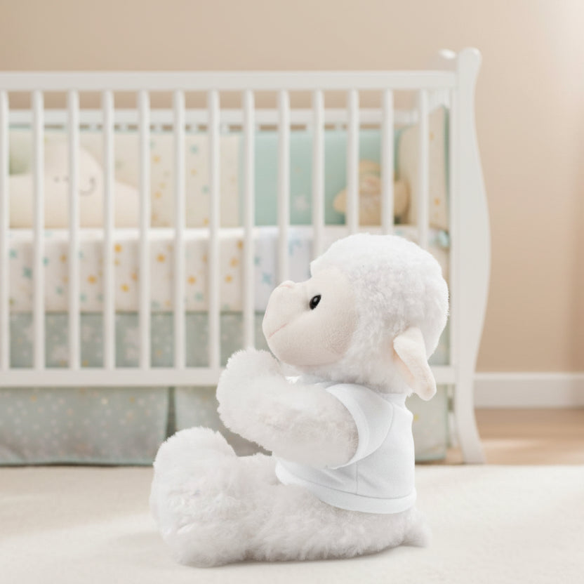 Plush lamb toy with a white t-shirt and in a nursery.