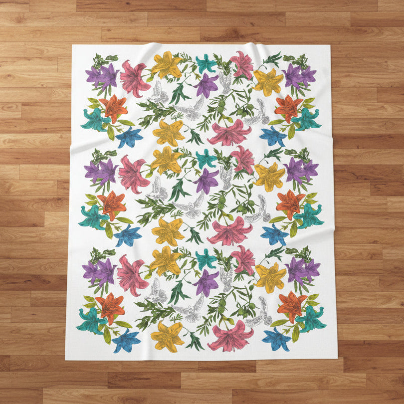 Floral and dove patterned blanket on a wooden floor