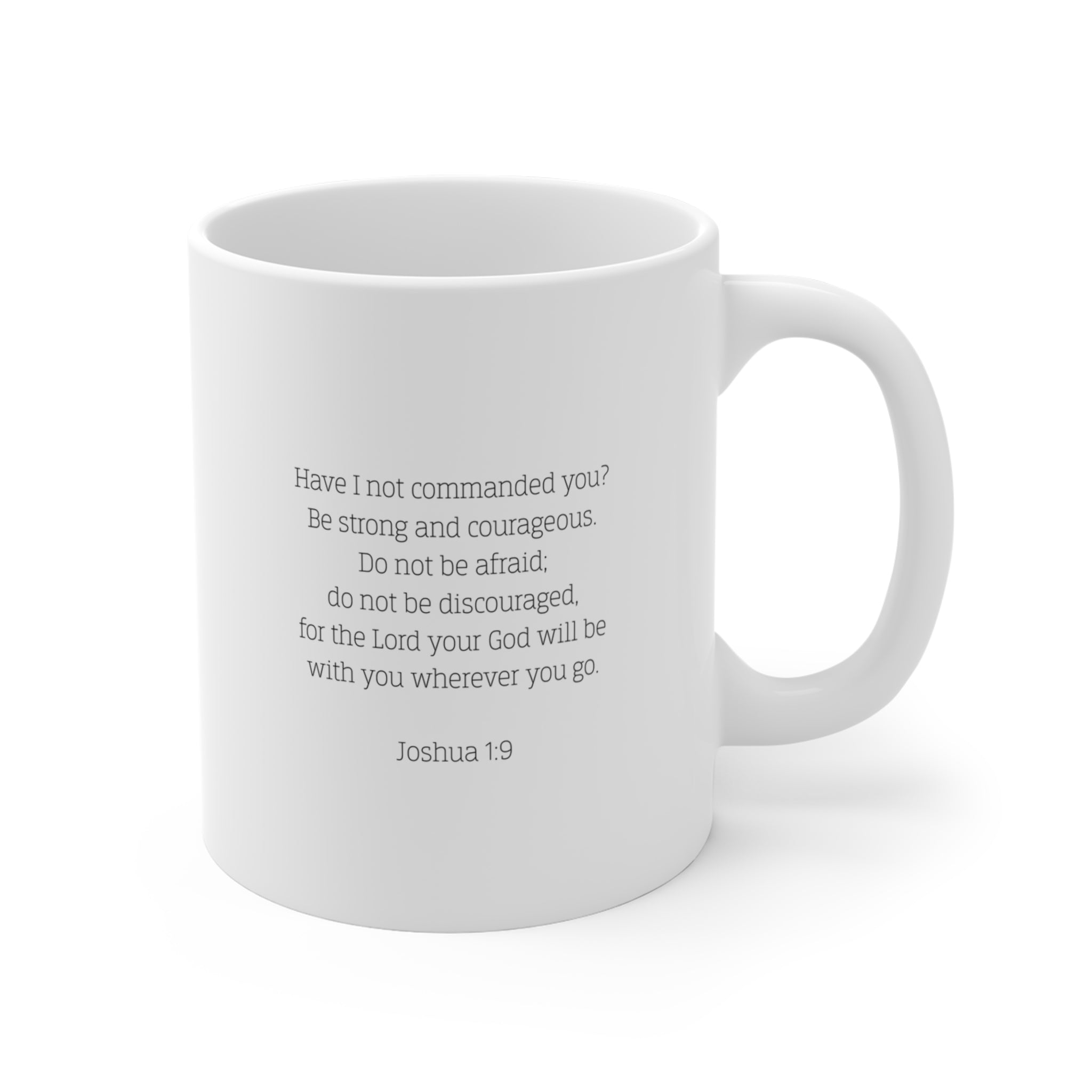 Back of white mug with the Biblical verse Joshua 1:9 typed on the back against a white background.