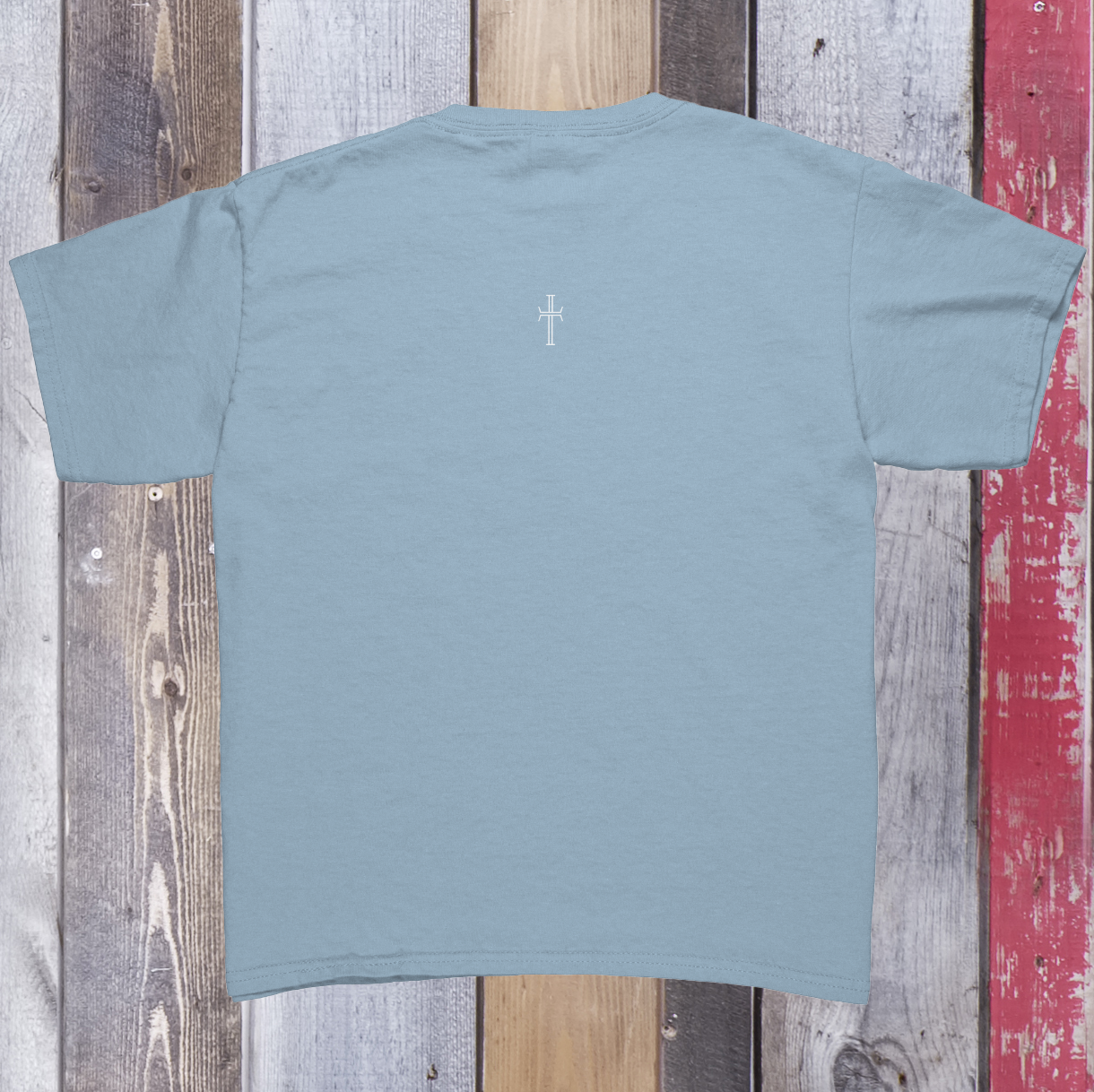 Back view of the light blue t-shirt with the Purpose cross logo on the upper back center of the garment.