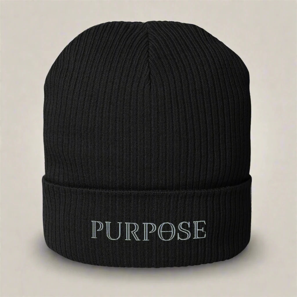 A black organic cotton beanie with the word 'Purpose' written on the fold.