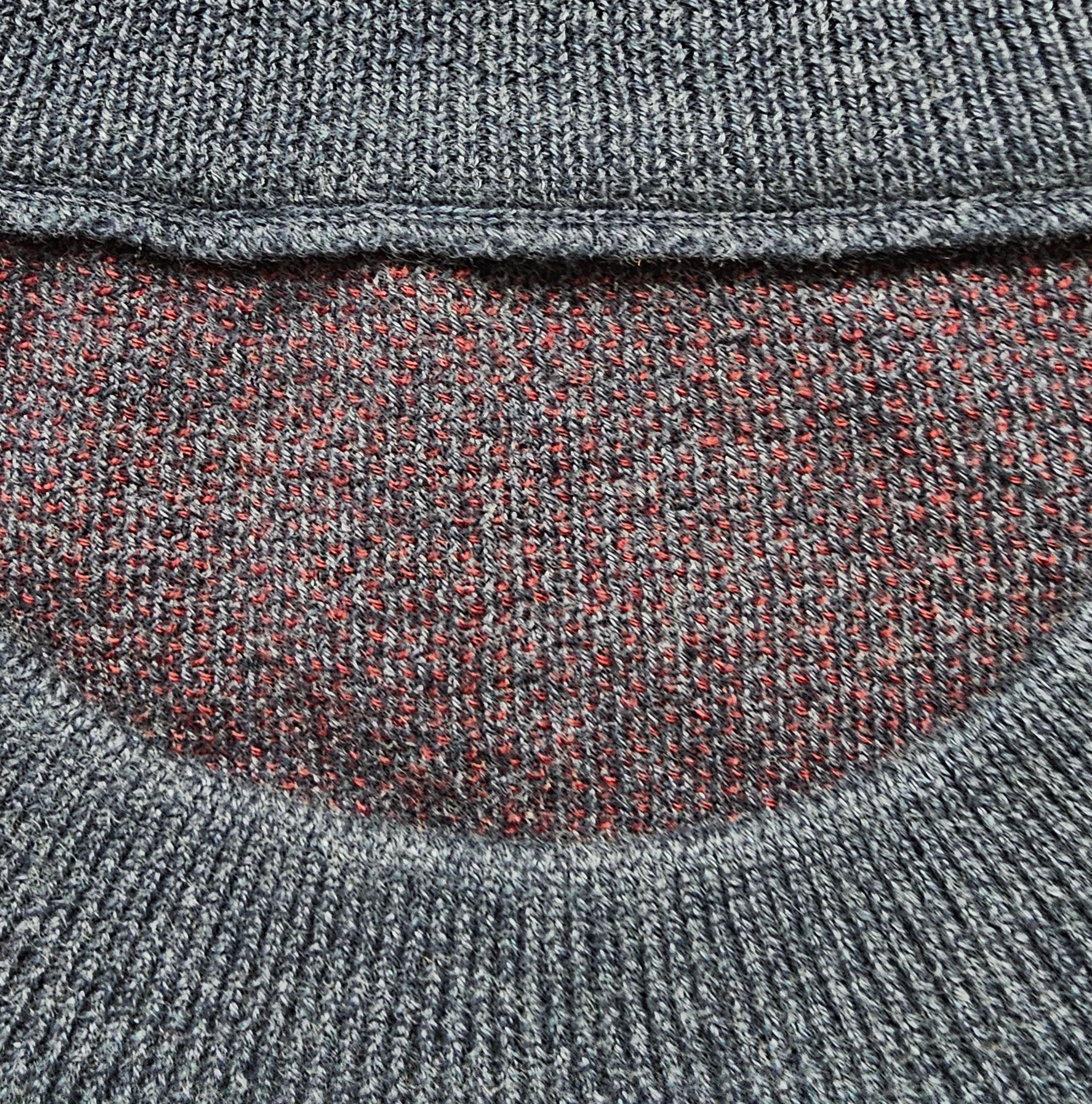 Close-up of the inner knitted seams of the crewneck sweater.