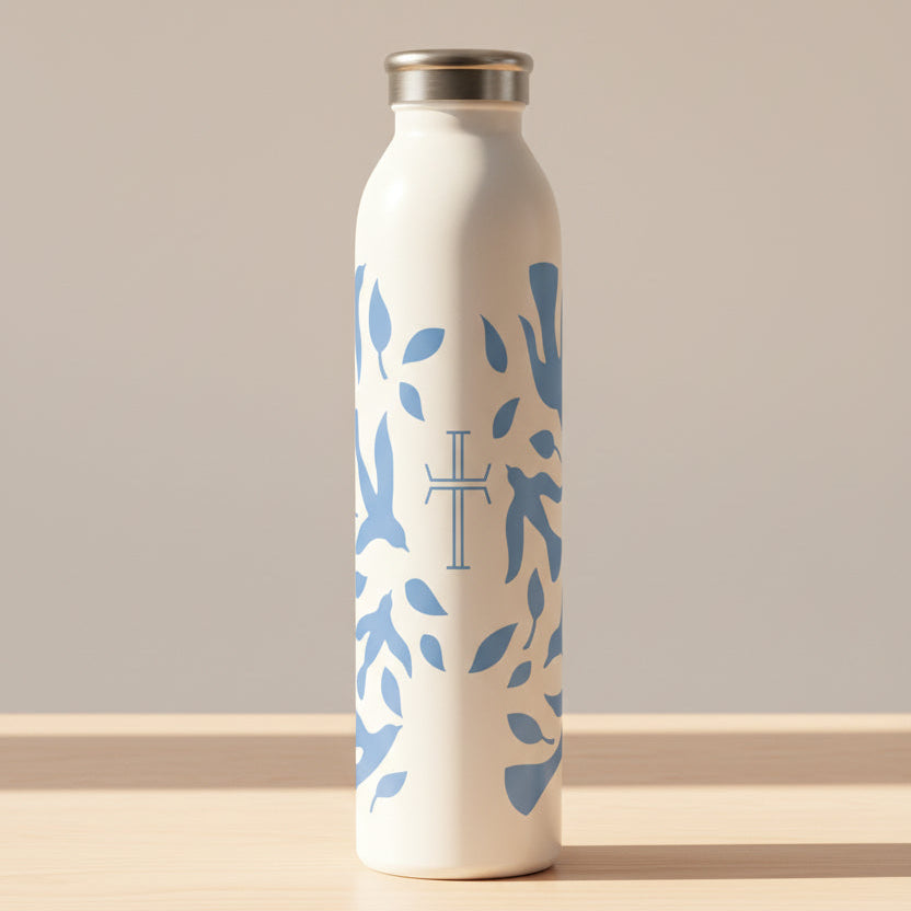 White water bottle with blue dove pattern and cross on a white background and wood table