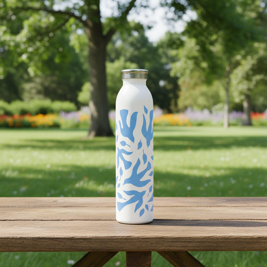 White water bottle with blue abstract dove pattern on a picnic bench at a park