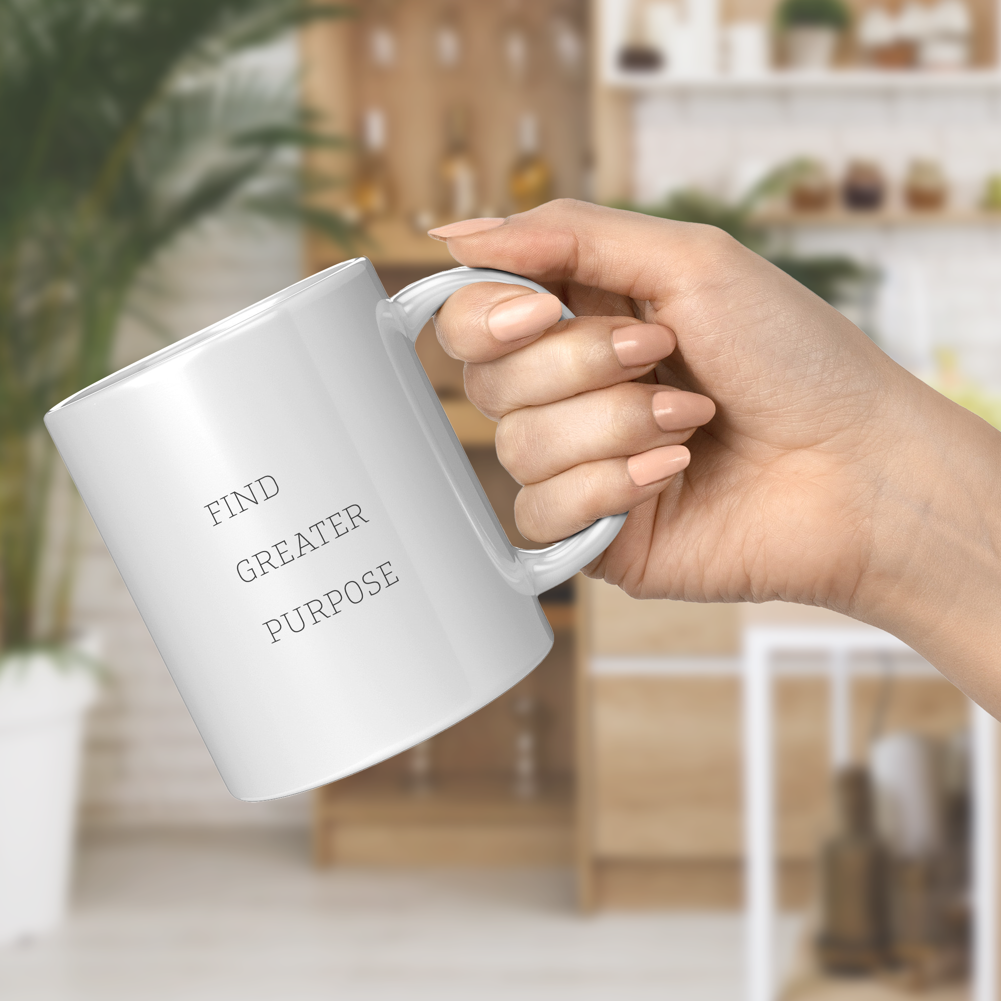 Female hand holding a white mug with 'Find Greater Purpose' text in a blurred indoor setting.