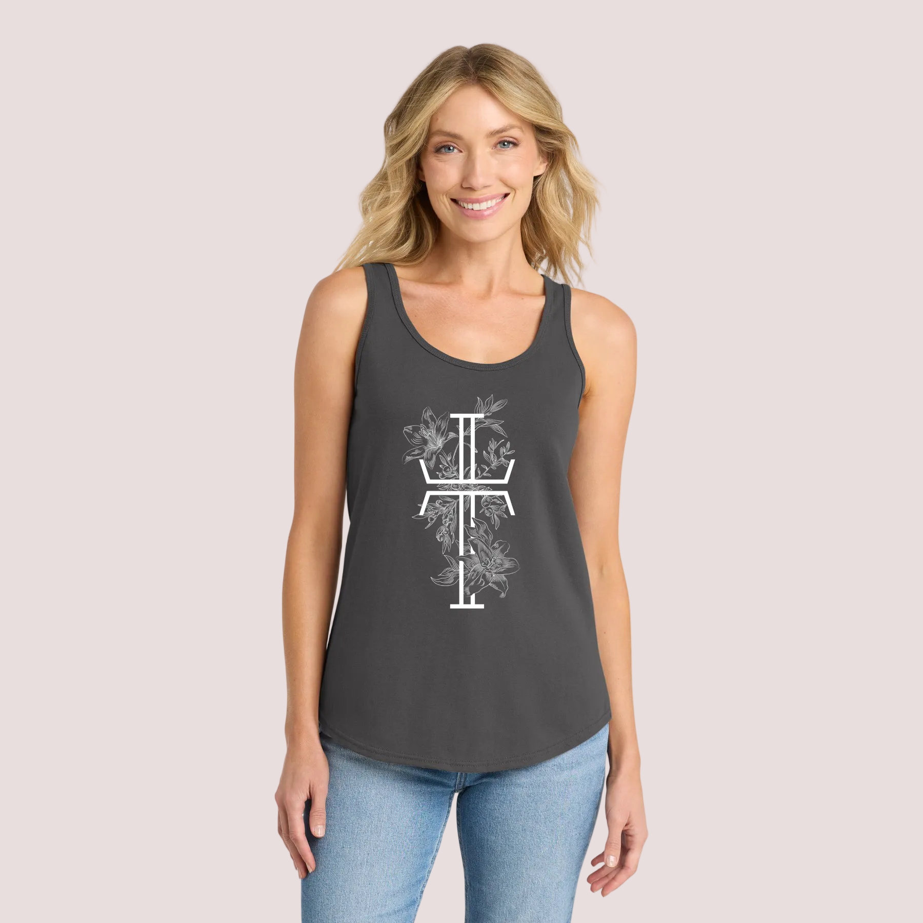 Woman wearing a dark gray tank top with a white floral Christian cross on a pale background