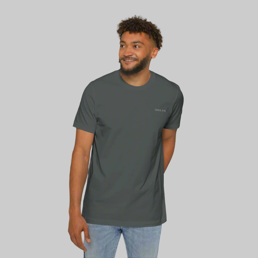 The front side of a male model wearing blue jeans and a gray tee shirt with the bible verse John 3:16 written in white on the left chest.