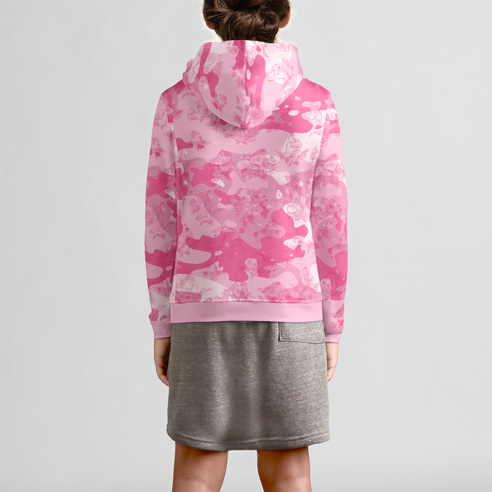 The back view of a female youth model in a gray skirt is wearing a pink-camo hoodie with a dark pink, all-over print line drawing of swimming carp.